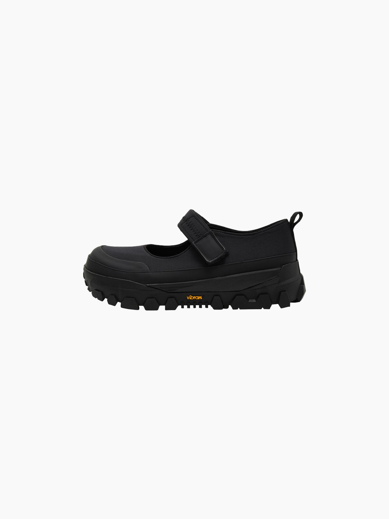 The Amomento Mary Jane Shoes Black feature a thick, rugged sole and a Velcro closing strap over the top. These shoes also include a pull-tab at the heel and have a logo on the side of the soft sole.