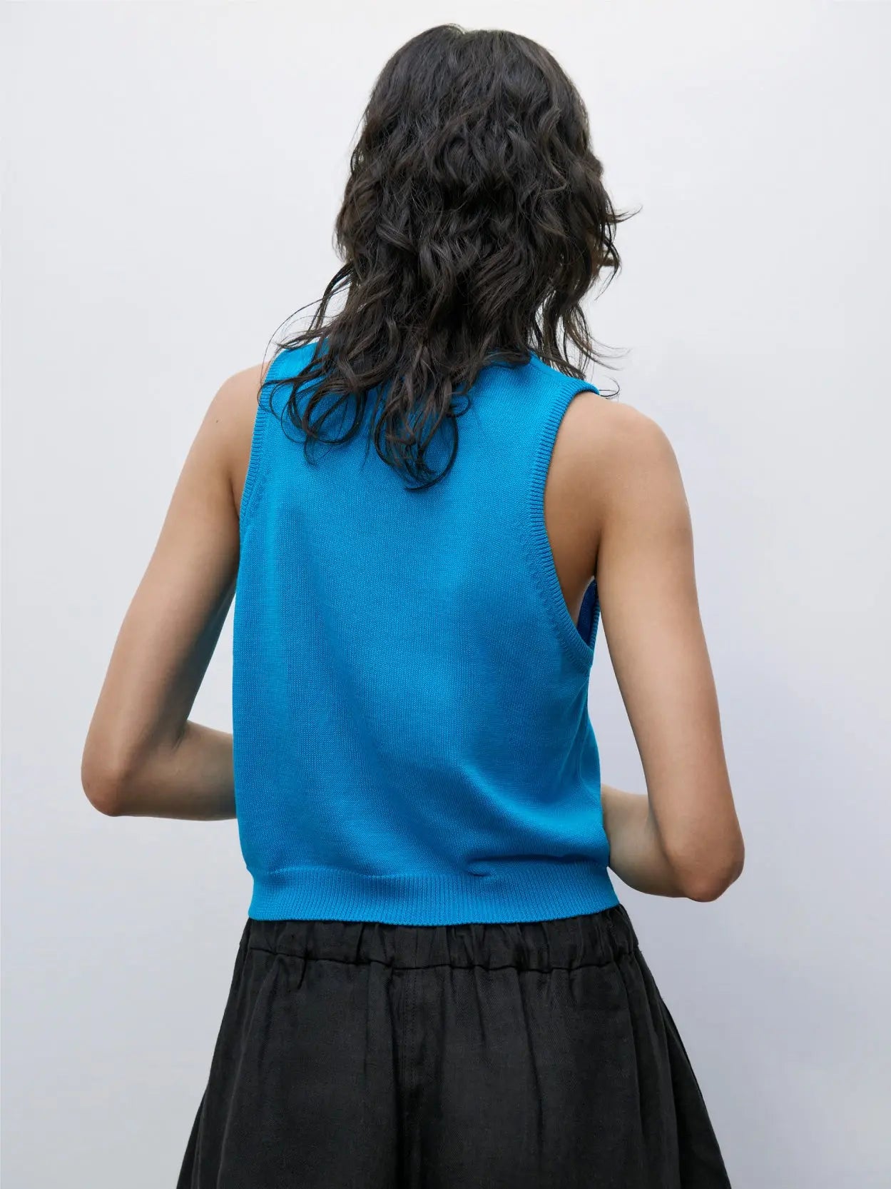 A Cotton Cropped Tank Top Ceruleo with a round neckline, crafted from a knit fabric. A small off-white label with black text "Cordera" is visible on the inside back of the neck. The top is displayed against a plain white background, available exclusively at Bassal Store in Barcelona.