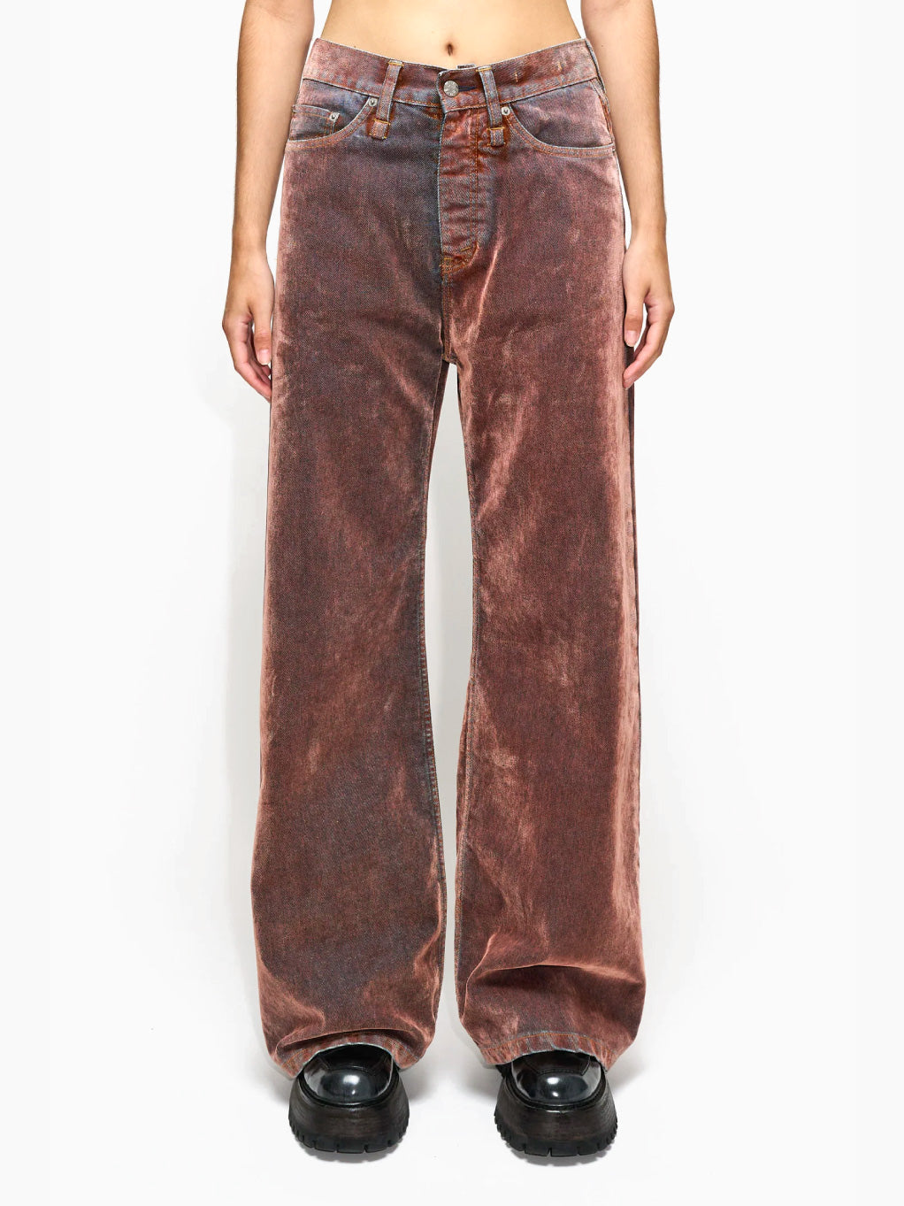 The HOPE Skid Jeans in Rust Flock are vintage-style, wide-legged brown jeans made from Organic Cotton with a faded finish and high waist. They feature classic five-pocket styling and prominent stitching, and are displayed laid flat against a white background.