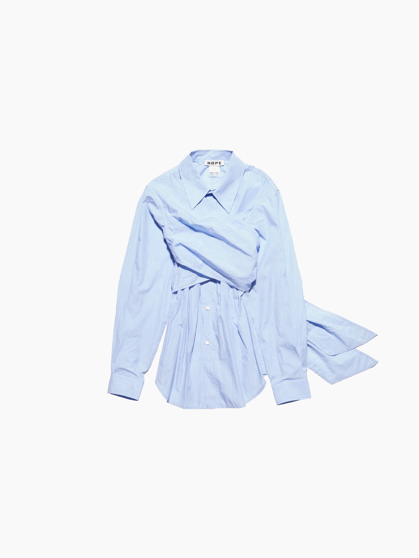 The Twisty Shirt Office Blue Stripe from Hope is crafted from striped cotton fabric in a light blue hue. This long-sleeved shirt features buttons down the front, a waist tie detail, and an oversized, structured collar for a chic touch.