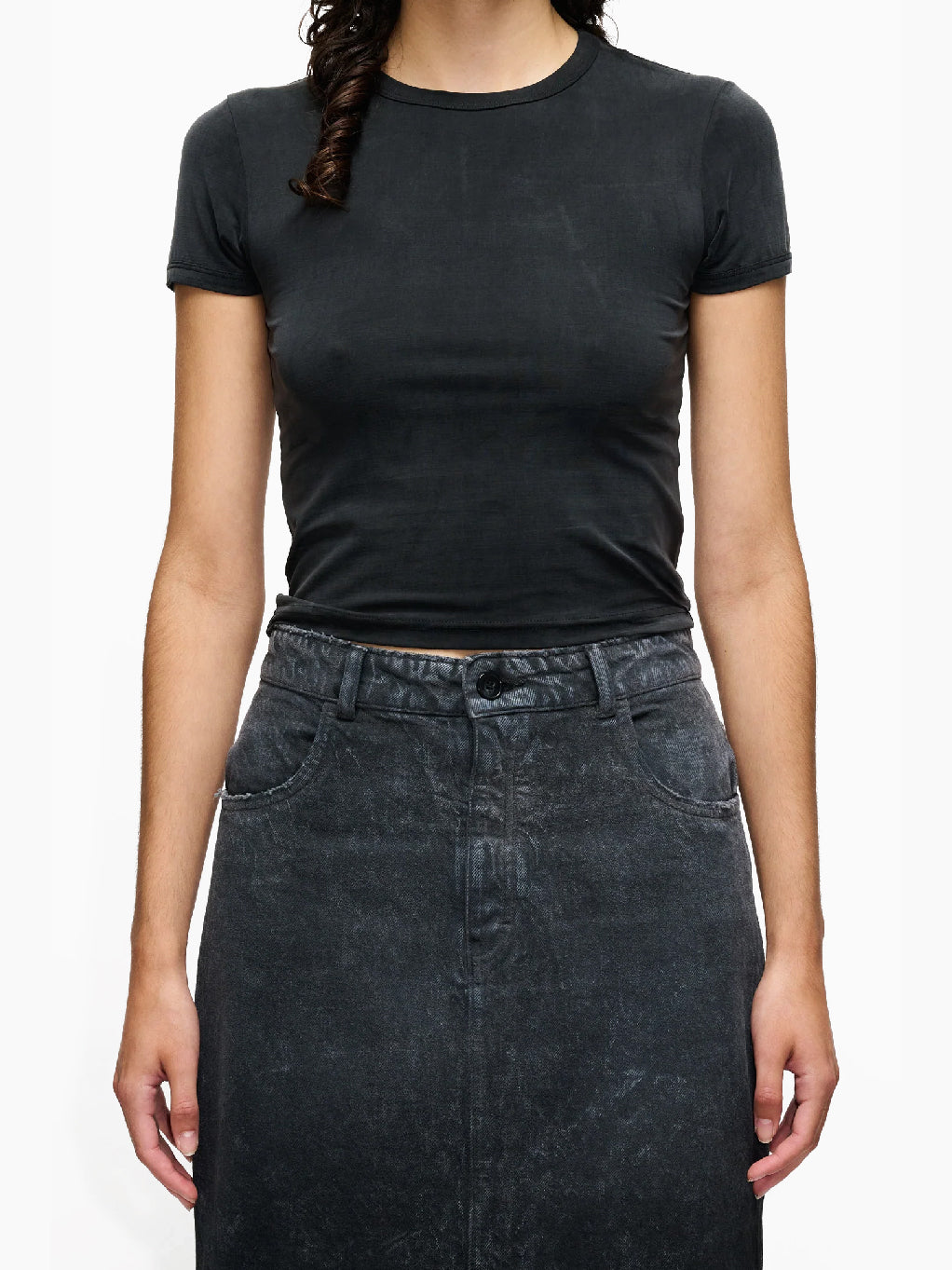 A short-sleeve, black velvet Vile T-Shirt Black, with a slight wrinkling on the front, laid flat on a white background. The collar label reads "Hope." This t-shirt boasts a washed silky look, adding an extra touch of elegance.