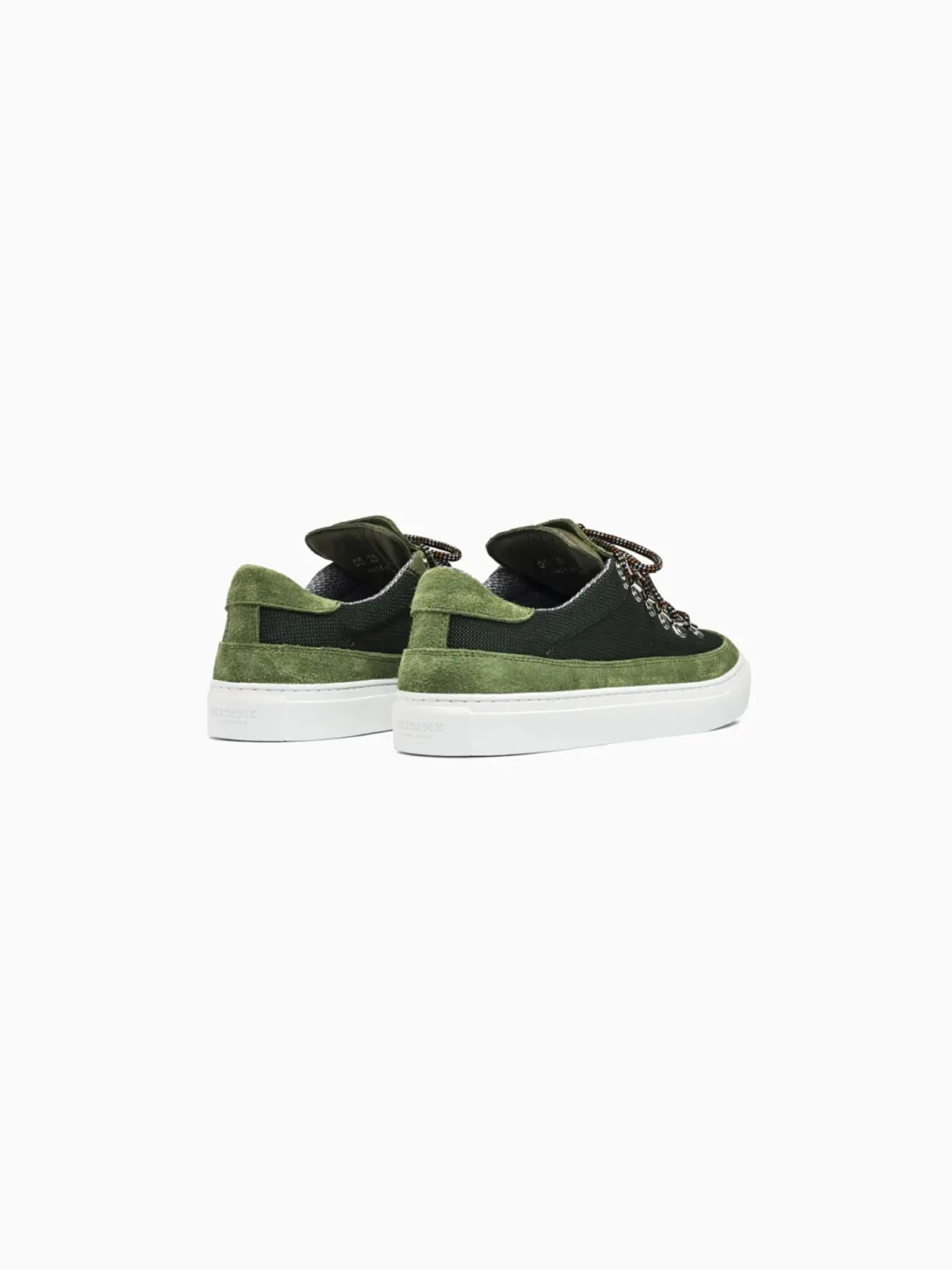 A single Marostica Low Evergreen sneaker by Diemme, from Bassal Store in Barcelona, is displayed on a white background. The shoe features bright green laces, silver eyelets, and a white sole. The upper part is made with a mix of dark green and olive green fabric, giving it a textured appearance.