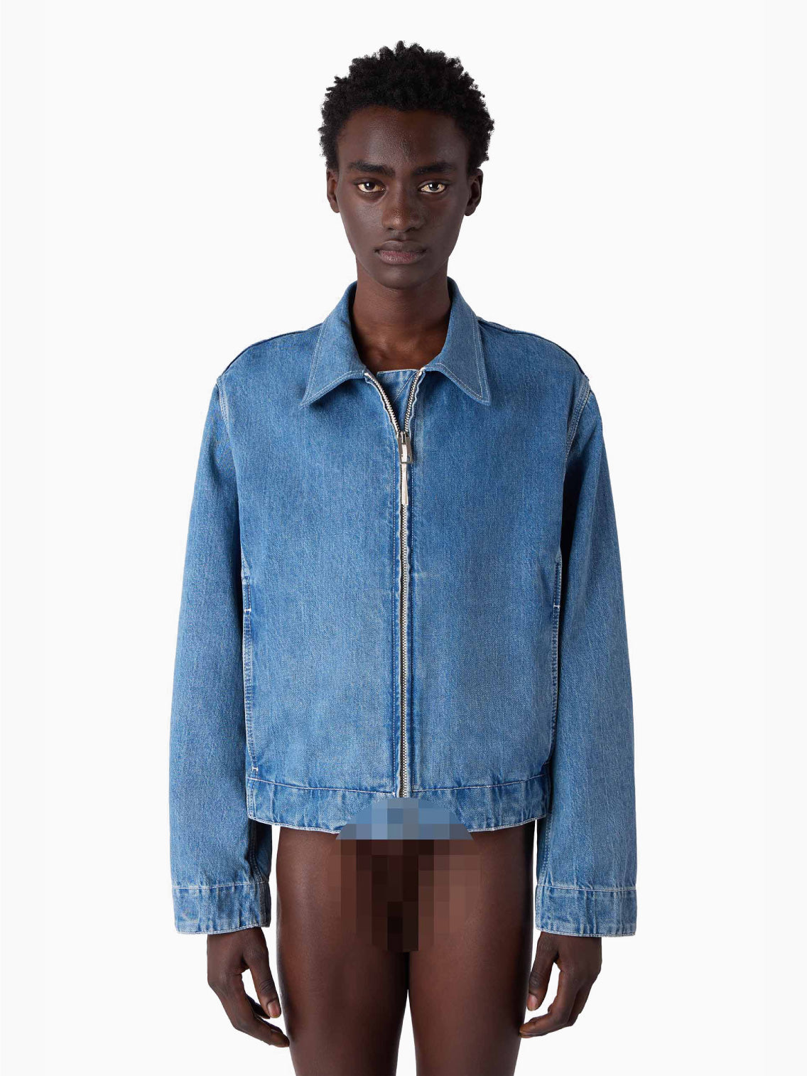A light blue, organic bomber jacket made from raw denim, featuring a front zipper and long sleeves. The jacket includes a collar and two front pockets, exuding a casual, slightly faded look. A silicon Sunnei patch adds a unique touch, while the fabric tag inside the collar reads "Marni.