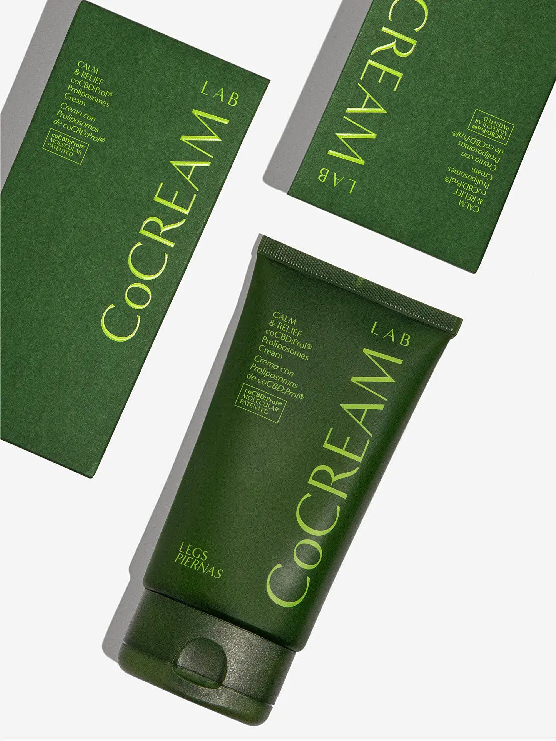 A green tube of Legs Cream 150ml by CoCream Lab with white text printed on the back. The text includes information about the product in multiple languages, ingredients, directions for use, and manufacturer details. Available at Bassalstore in Barcelona, the tube stands upright on a white background.