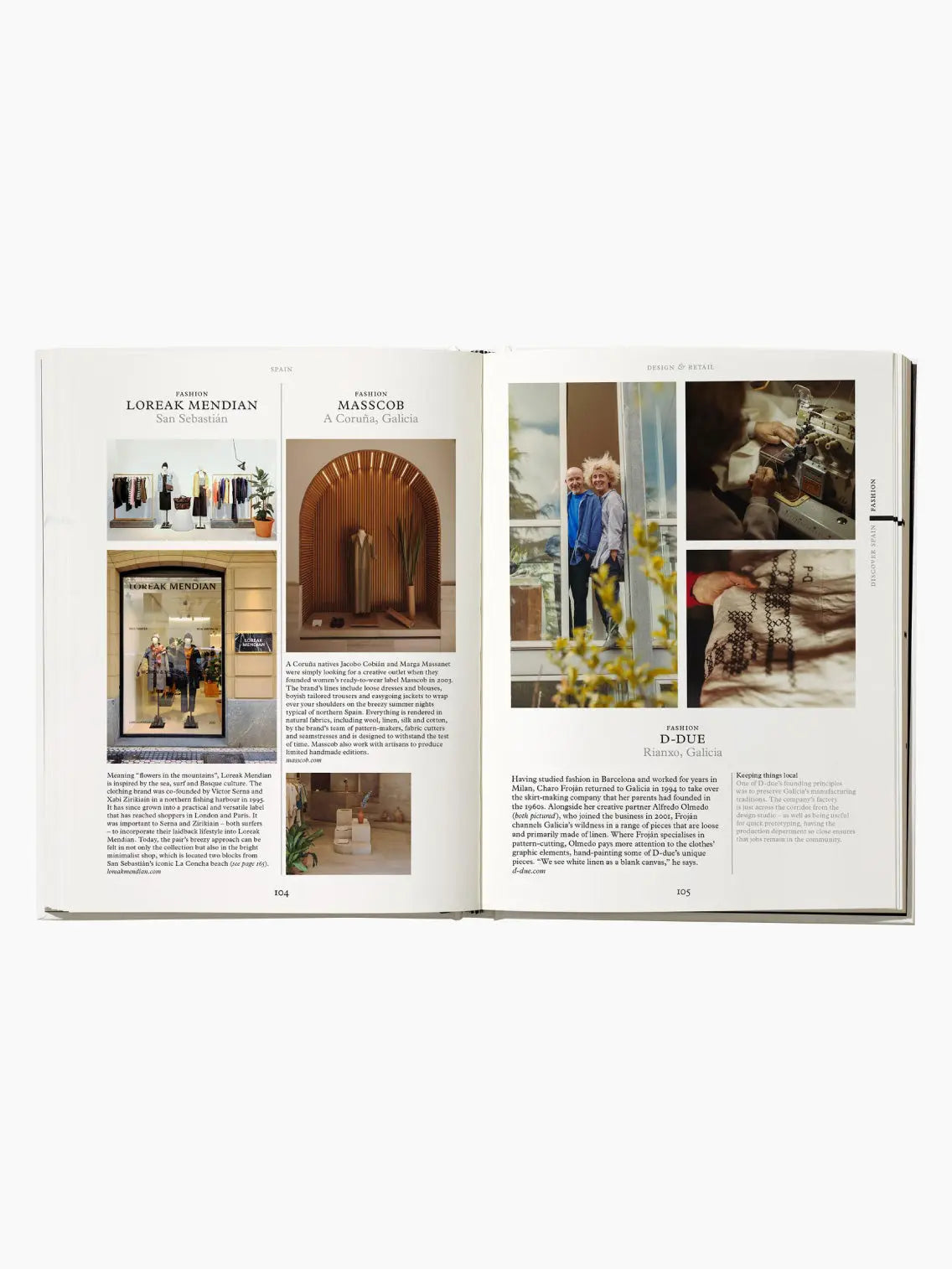 The cover of "Spain: The Monocle Handbook" showcases a modern architectural building in Barcelona with arches and a plate of shrimp paired with a glass of beer. Text on the cover reads, "Hotels, food, design: rediscover Spain with this insightful guide from Monocle.