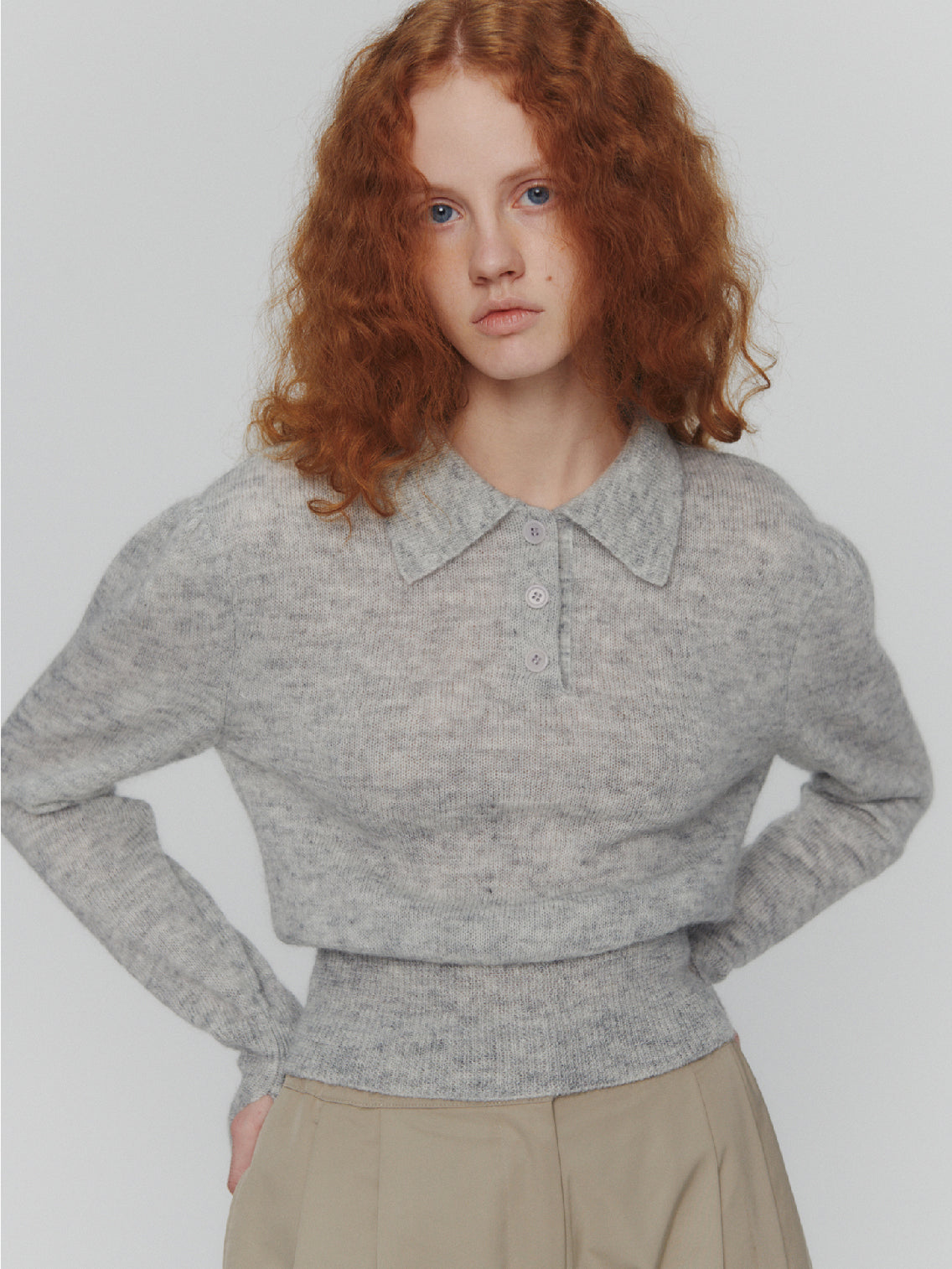 The Amomento Mohair Collar Knit Grey sweater, featuring long sleeves and a quarter zip at the front, is laid out flat on a plain white background. This woolen sweater includes a mohair collar and has ribbed cuffs and hem for added texture.