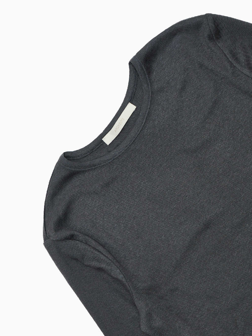 The "Round T-Shirt Charcoal" by Amomento is showcased against a plain white background. This dark gray, long-sleeve t-shirt made from wool tencel features a round neckline and a simple, minimalist design with no visible logos or patterns, making it a versatile addition to any wardrobe.