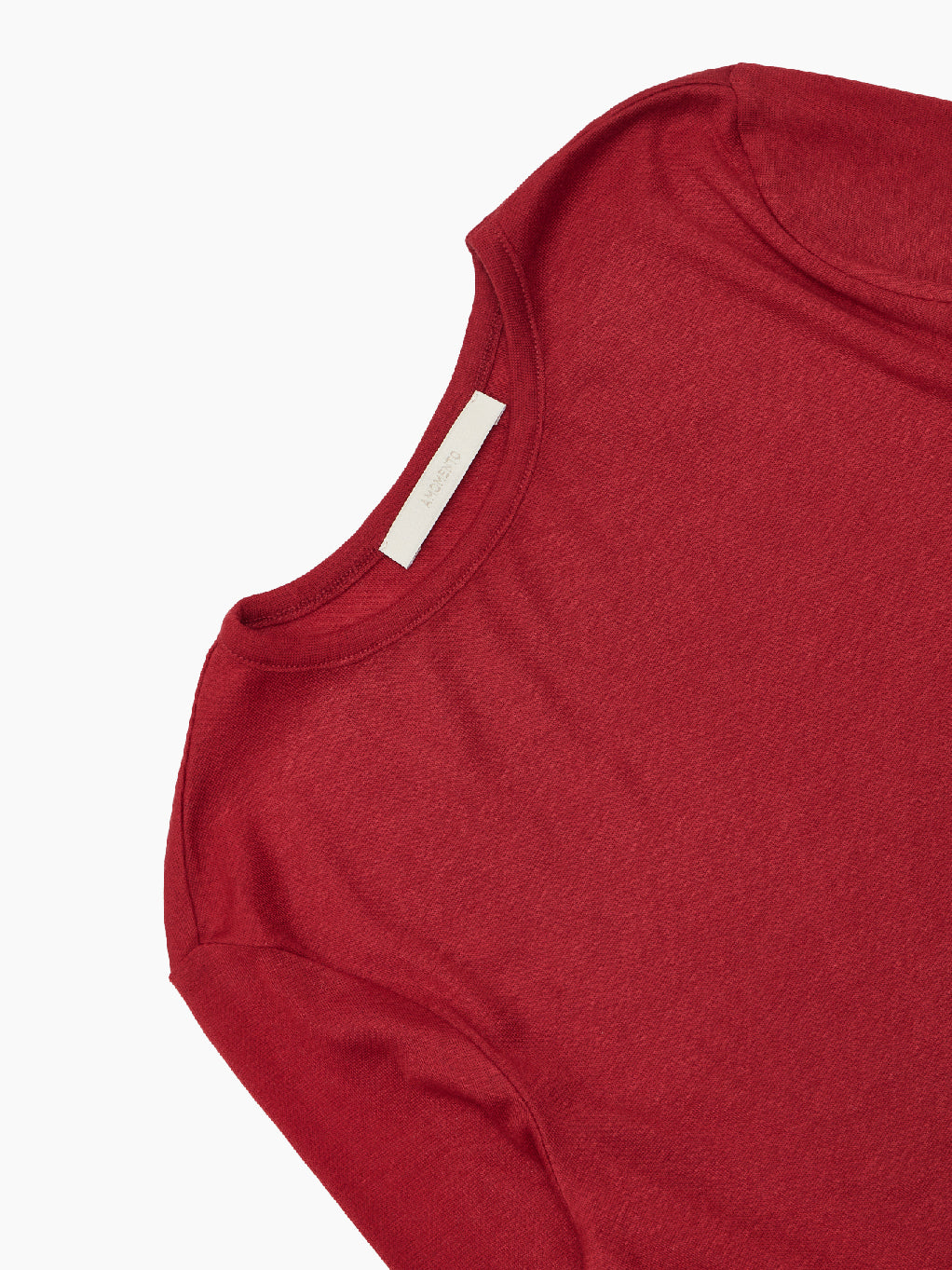 A plain, long-sleeved Round T-Shirt Red by Amomento, crafted from wool tencel, is displayed against a white background. The versatile top features a round neckline and appears to be made of a lightweight material, perfect for comfortable wear.