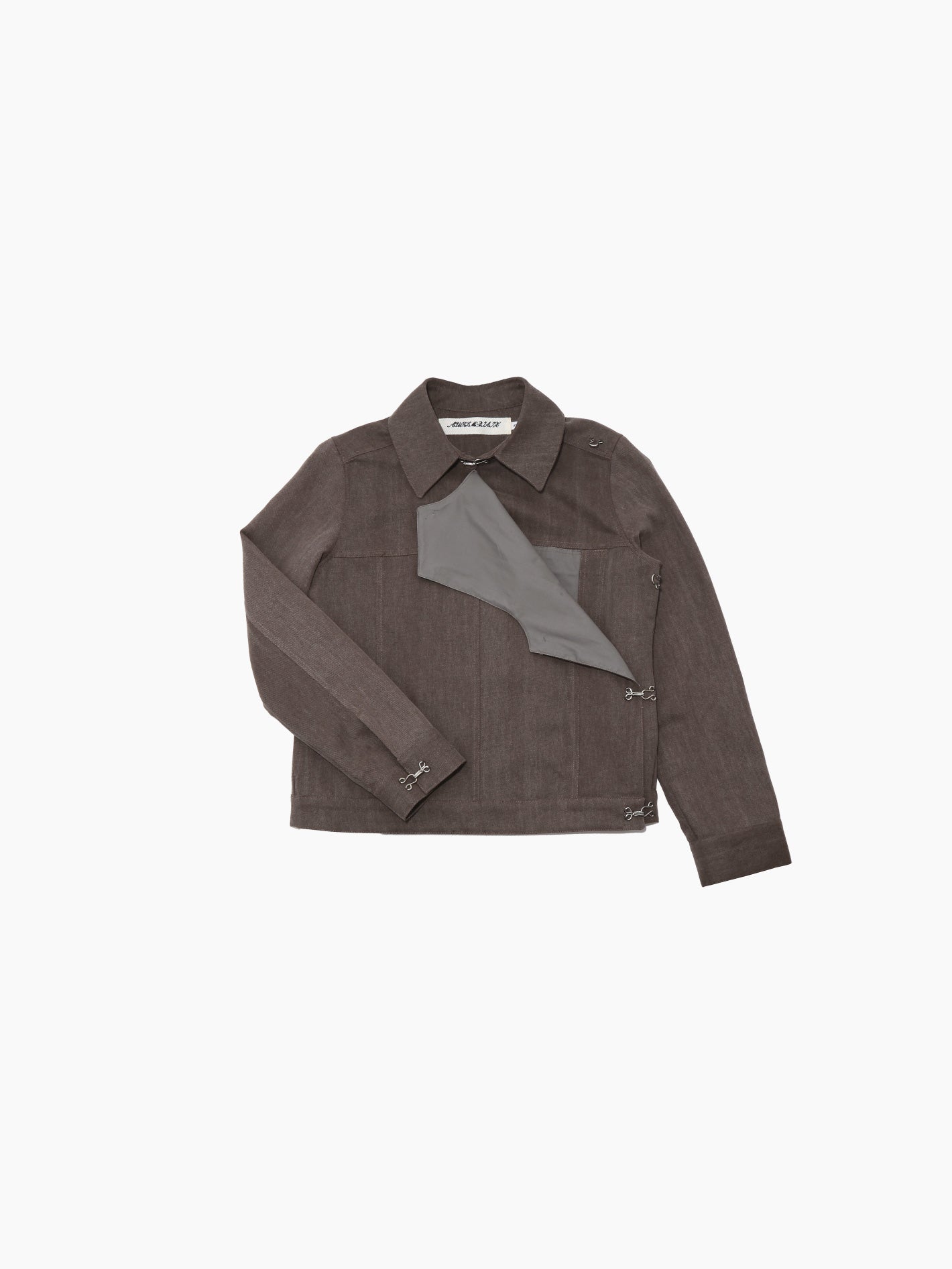 Aurembiaix's Canvas Jacket is a minimalist gray, long-sleeved canvas jacket with a pointed collar and hook and eye fastening closures on the right side. Made from 100% cotton, it boasts a straight hem and no visible pockets, displayed against a plain white background.