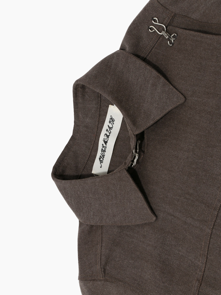 Aurembiaix's Canvas Jacket is a minimalist gray, long-sleeved canvas jacket with a pointed collar and hook and eye fastening closures on the right side. Made from 100% cotton, it boasts a straight hem and no visible pockets, displayed against a plain white background.