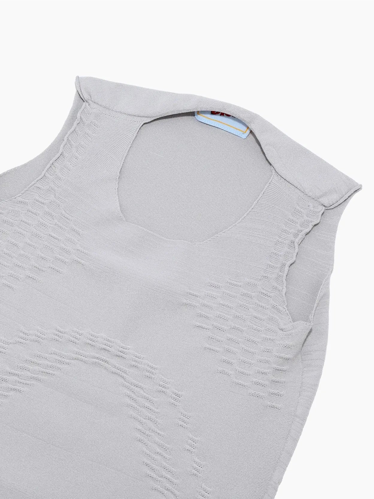 A sleeveless, light gray baby onesie called Alet Body Grey by Bielo with a round neckline and snap closures at the bottom, available exclusively at Bassalstore. The soft, slightly textured fabric ensures comfort. The onesie is laid flat on a white background.