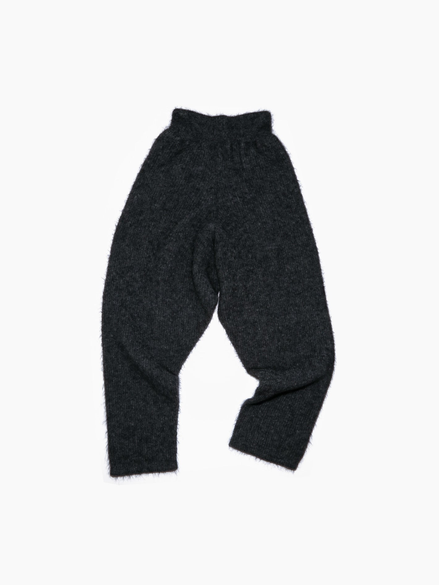 The Bielo Brais Trousers Grey are loose-fitting, dark gray fuzzy pants crafted from superkid mohair, displayed laid flat on a white background. They feature a high waistband and tapered legs, offering both comfort and style.