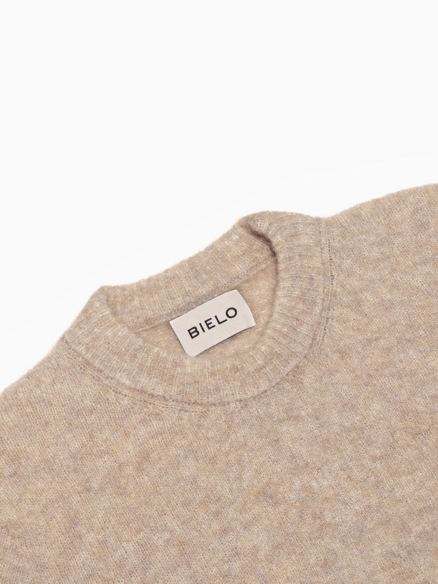 A brown Mael Sweater by Bielo, crafted from extrafine merino wool with long sleeves and a round collar, laid flat against a white background.