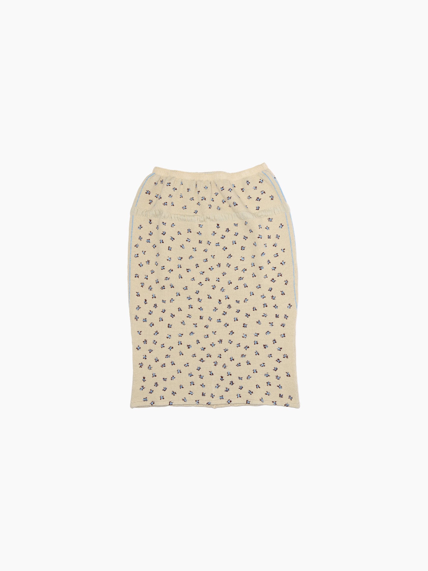 The Rina Skirt Beige by Bielo is a soft, lightweight beige skirt with a dark floral pattern, made from fine merino wool. It features a gathered waistband and has a straight cut, elegantly lying flat against a plain white background.