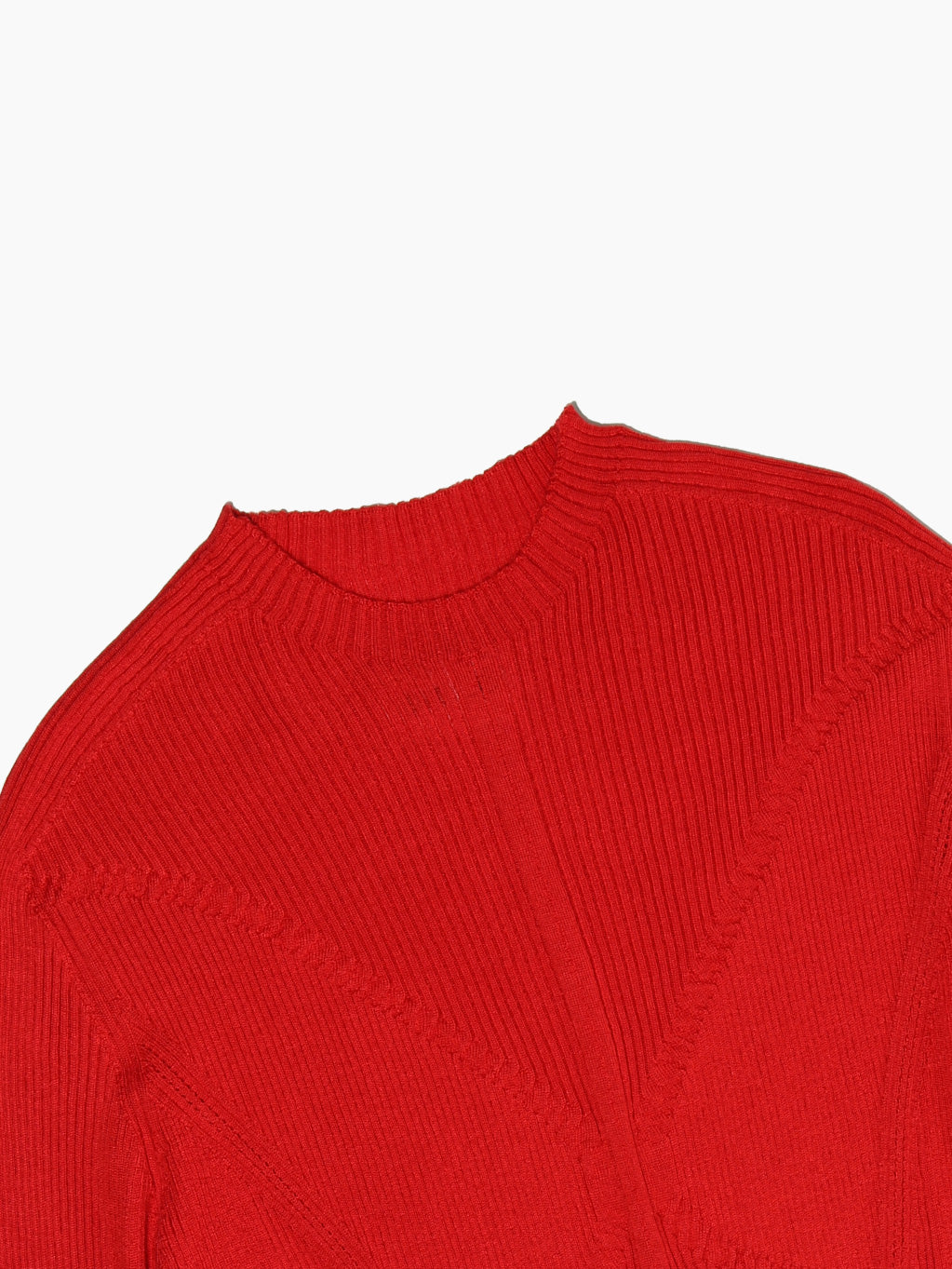 The Tisa Sweater Red by Bielo is showcased against a white background, highlighting its vibrant red hue. This cashmere sweater, crafted in Spain, boasts a fitted design with a ribbed texture and a crew neckline, expertly merging style and quality.