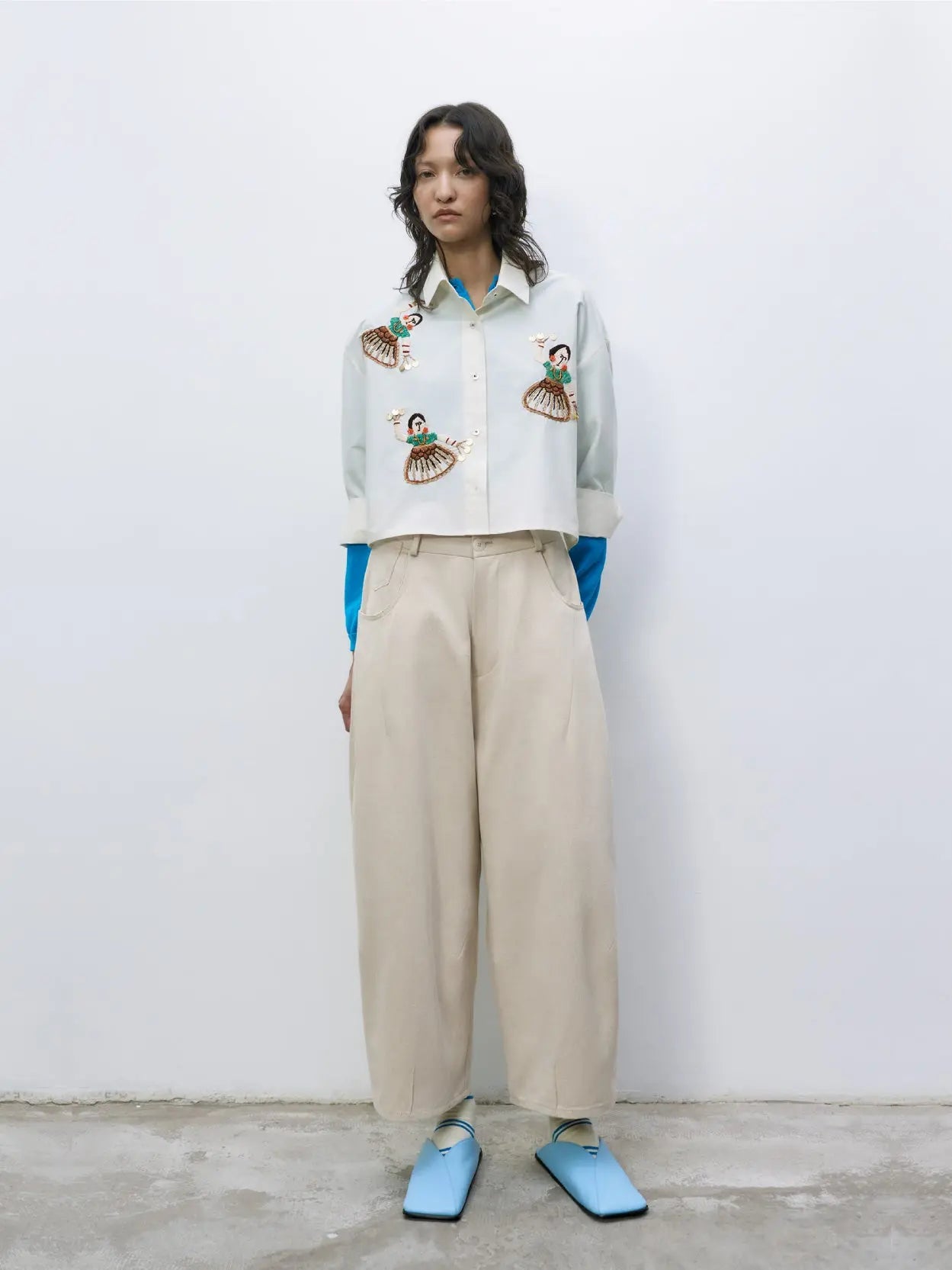 A pair of beige Baggy Pants Alabaster by Cordera with a high waist and a loose, slightly tapered fit, available at Bassal Store in Barcelona. The pants feature a button and zipper closure, belt loops, and front pockets. The fabric appears smooth and lightweight.