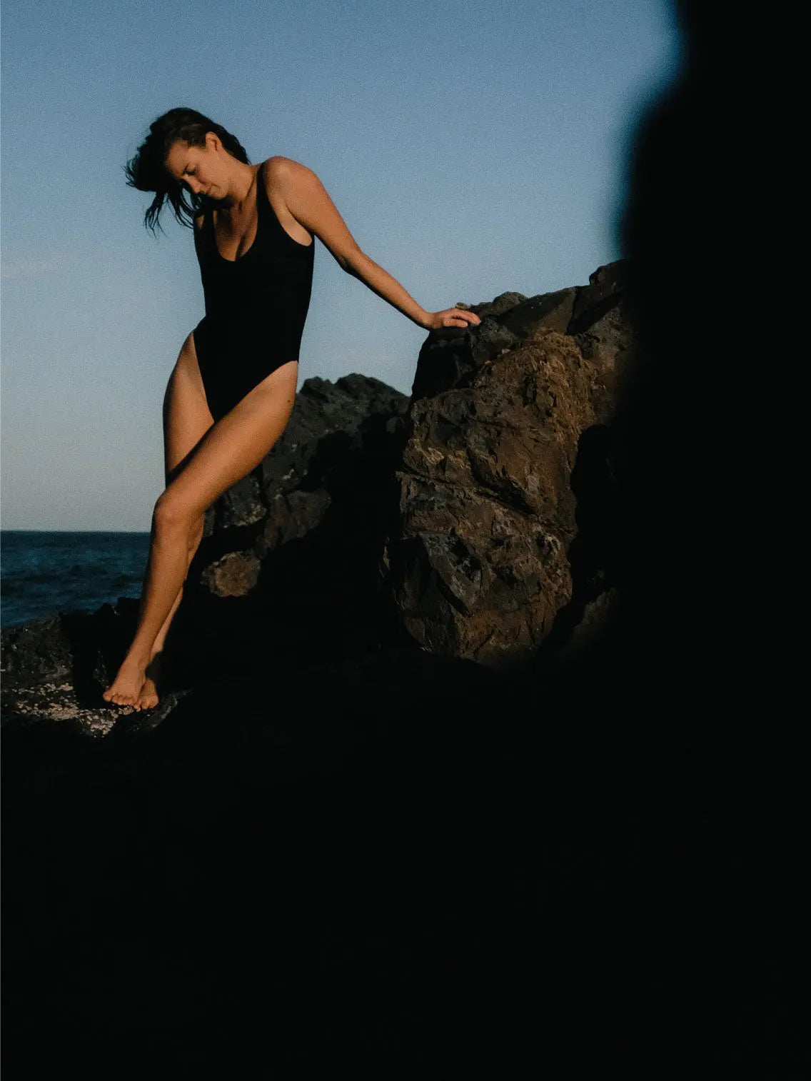 A Black Contrast One Piece Swimwear with wide shoulder straps and a scoop neckline from Innes Lauren in Barcelona. The swimsuit features simple, clean lines and a fitted design, with subtle horizontal stitching detail across the chest area. The fabric appears smooth and stretchy.