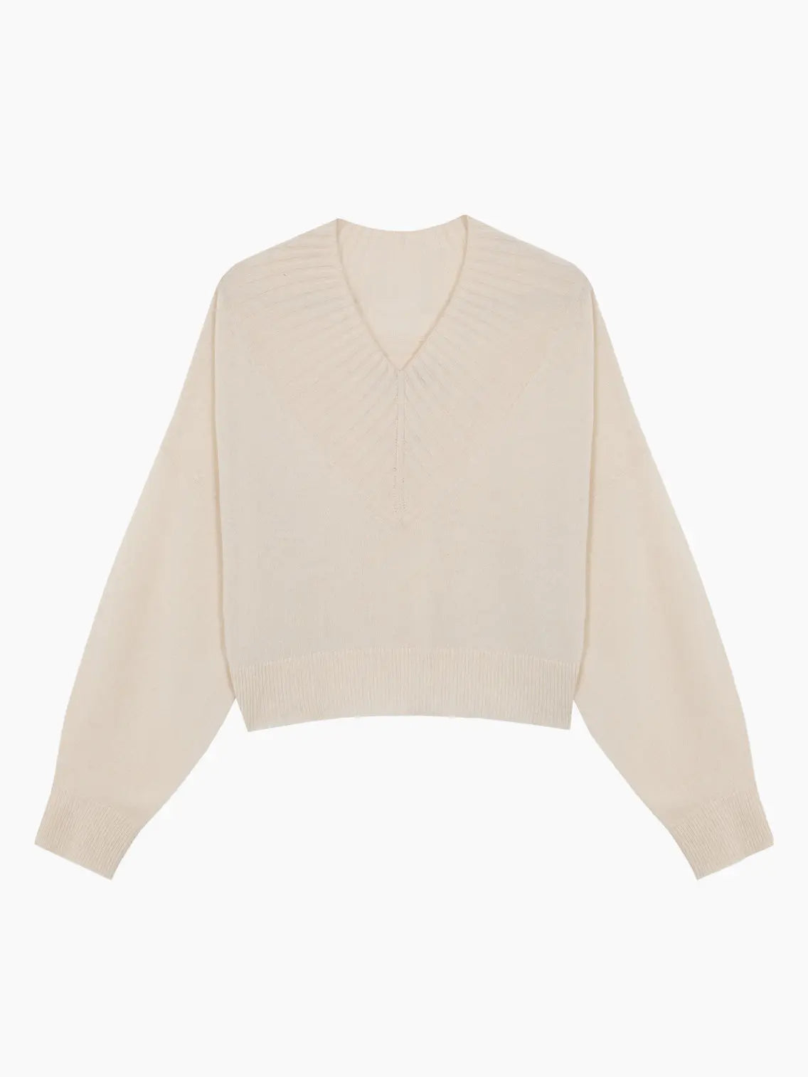 A cream-colored knit sweater with a V-neck collar and long sleeves. The Cashmere Ribbed Neck Sweater Natural by Cordera, available at Bassalstore, has a ribbed design on the neckline, cuffs, and hem, creating a cozy and slightly oversized look. It is laid out flat on a white background. Perfect for a stylish day in Barcelona.