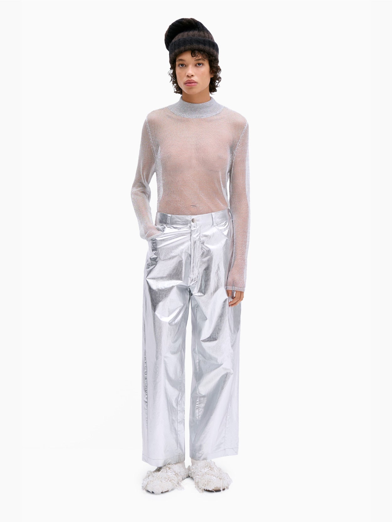 The Cotton & Silk Pants Silver by Cordera are a pair of metallic silver, superlight wide-leg pants featuring a high waist, front button and zipper closure, and side pockets. The fabric boasts a shiny, reflective finish. These cotton and silk blend pants are displayed flat against a plain white background.