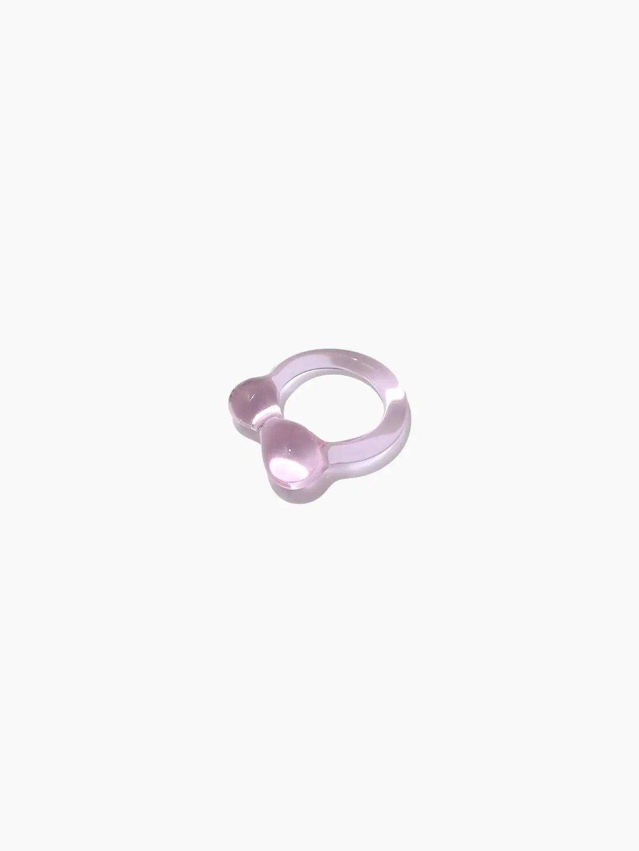 A pink ring-shaped baby teether with two round, textured ends designed for soothing a baby's gums during teething. Made of soft, rubber-like material, this essential item is the Caju Ring Rose by Nathalie Schreckenberg and is available at Bassalstore in Barcelona.