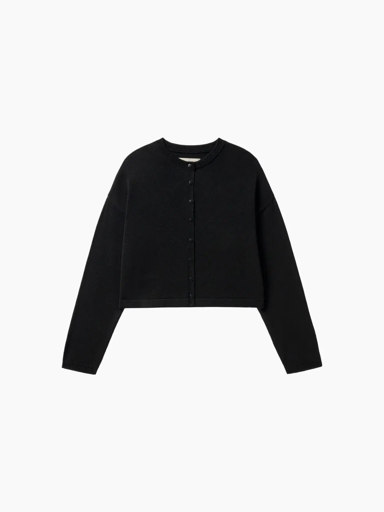 A Cordera Cotton Cropped Cardigan Black with a round neckline and button-down front. The slightly cropped, minimalist design is laid flat against a white background, available exclusively at Bassal Store in Barcelona.
