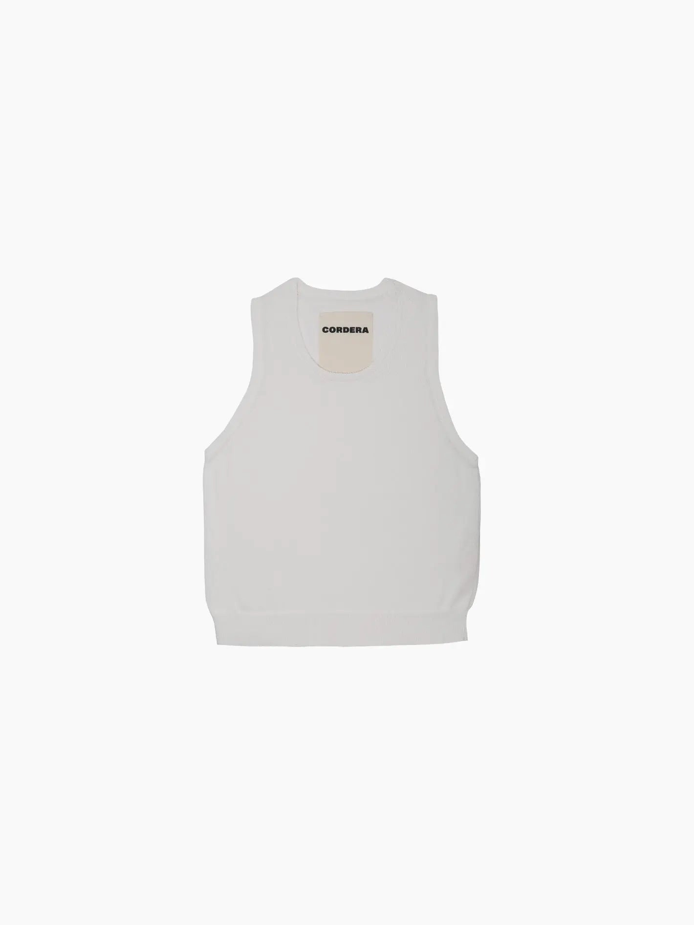 A sleeveless white Cotton Cropped Tank Top shown from the front against a plain white background. The Cotton Cropped Tank Top features a crew neckline, with the brand name "Cordera" visible on the tag inside the collar. Available exclusively at Bassalstore in Barcelona.