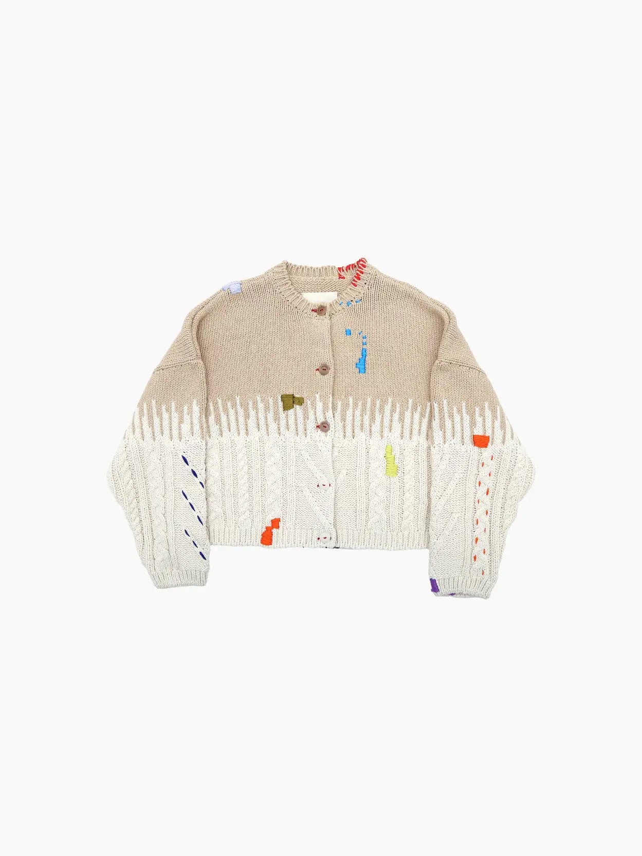 A beige and white knit cardigan with a mix of cable knit and ribbed textures, featuring colorful abstract patches in orange, blue, yellow, and purple. This chic piece from Cordera boasts brown buttons on its button-down front and a round neckline—perfect for adding Barcelona flair to your wardrobe.