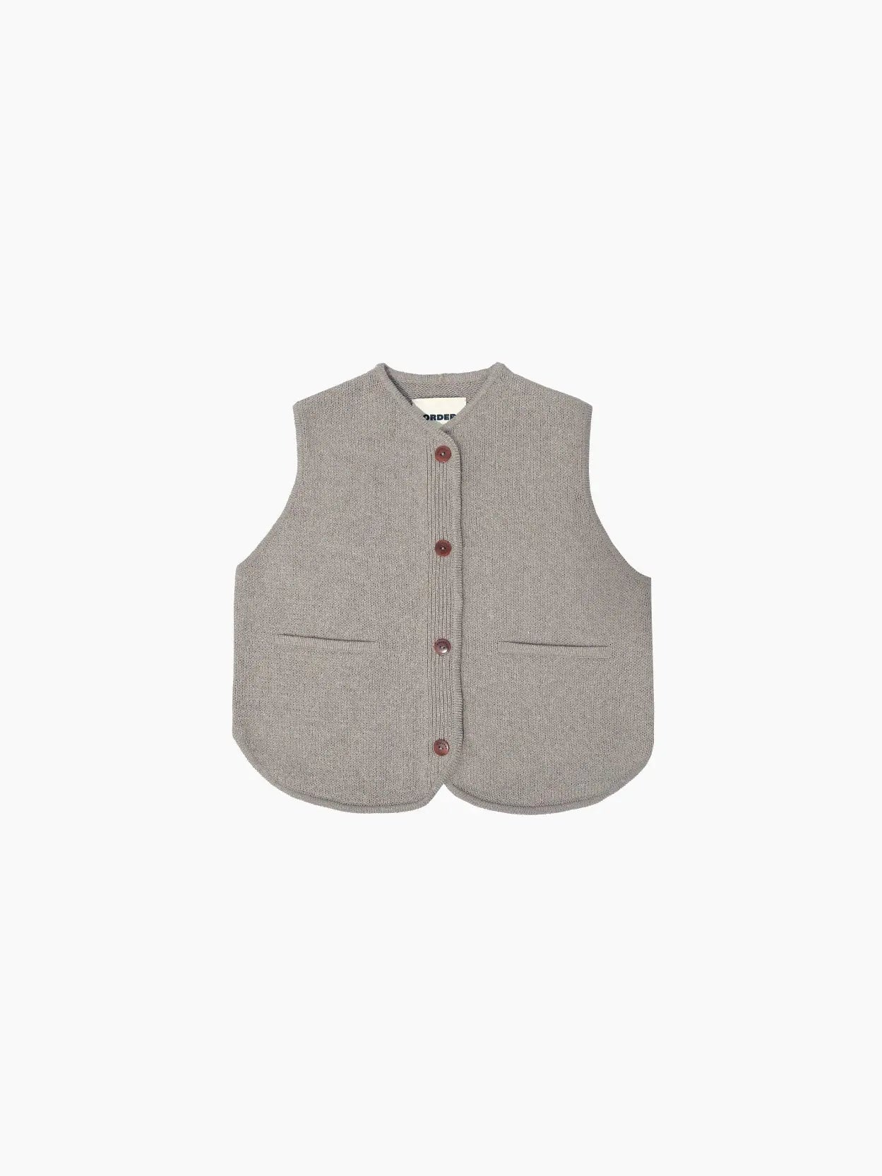 A gray sleeveless vest with a rounded hem, front buttons, and two side pockets. The Cotton Waistcoat Taupe by Cordera embodies a simple, minimalist design and is displayed against a plain white background. Available exclusively at Bassalstore in Barcelona.