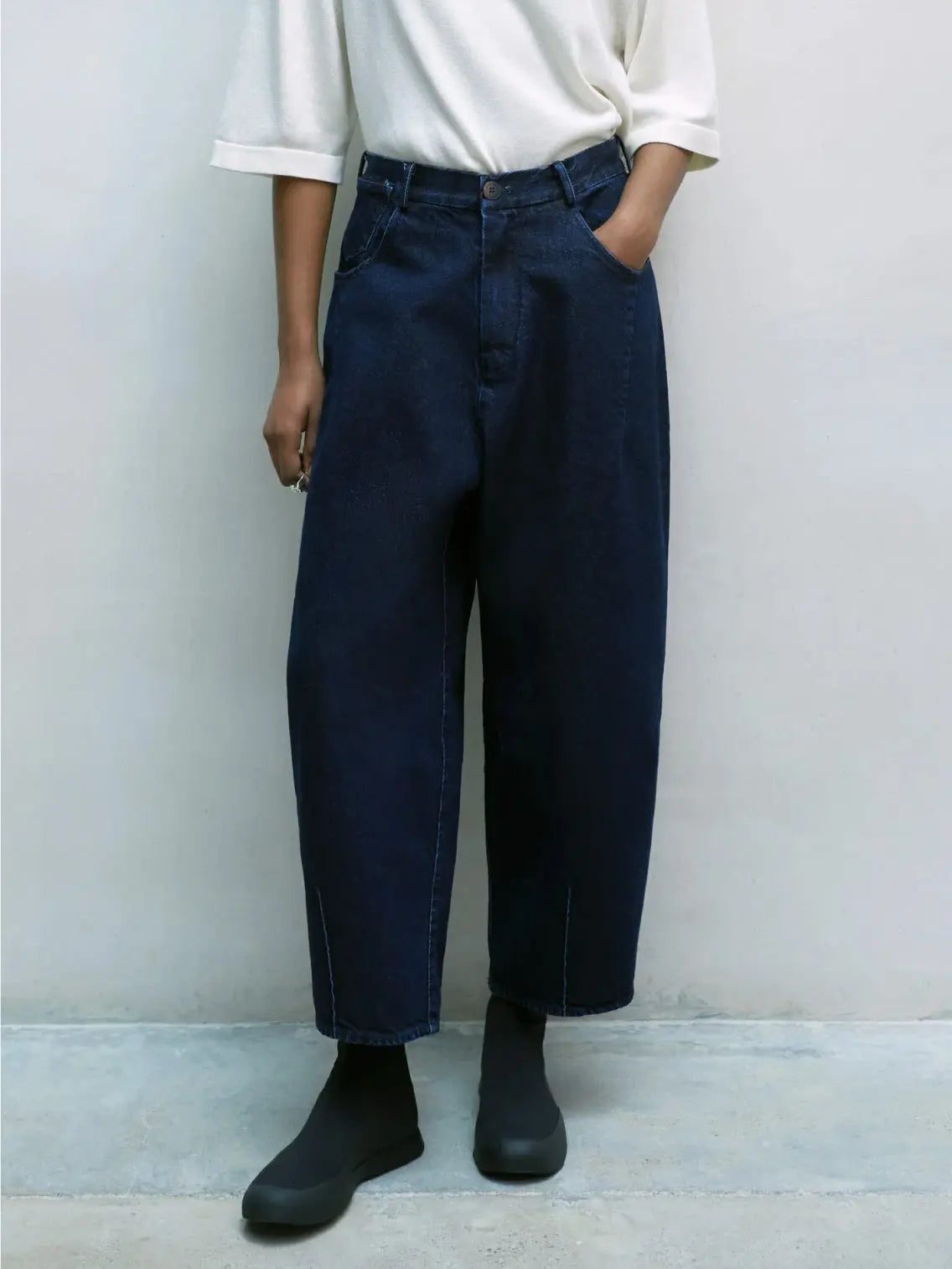 A pair of dark blue, high-waisted Denim Baggy Pants by Cordera with a relaxed, wide-leg fit. The pants feature side pockets, front zipper closure, and contrast stitching along the seams. Available at BassalStore in Barcelona, the fabric appears to have a slightly worn-in texture.