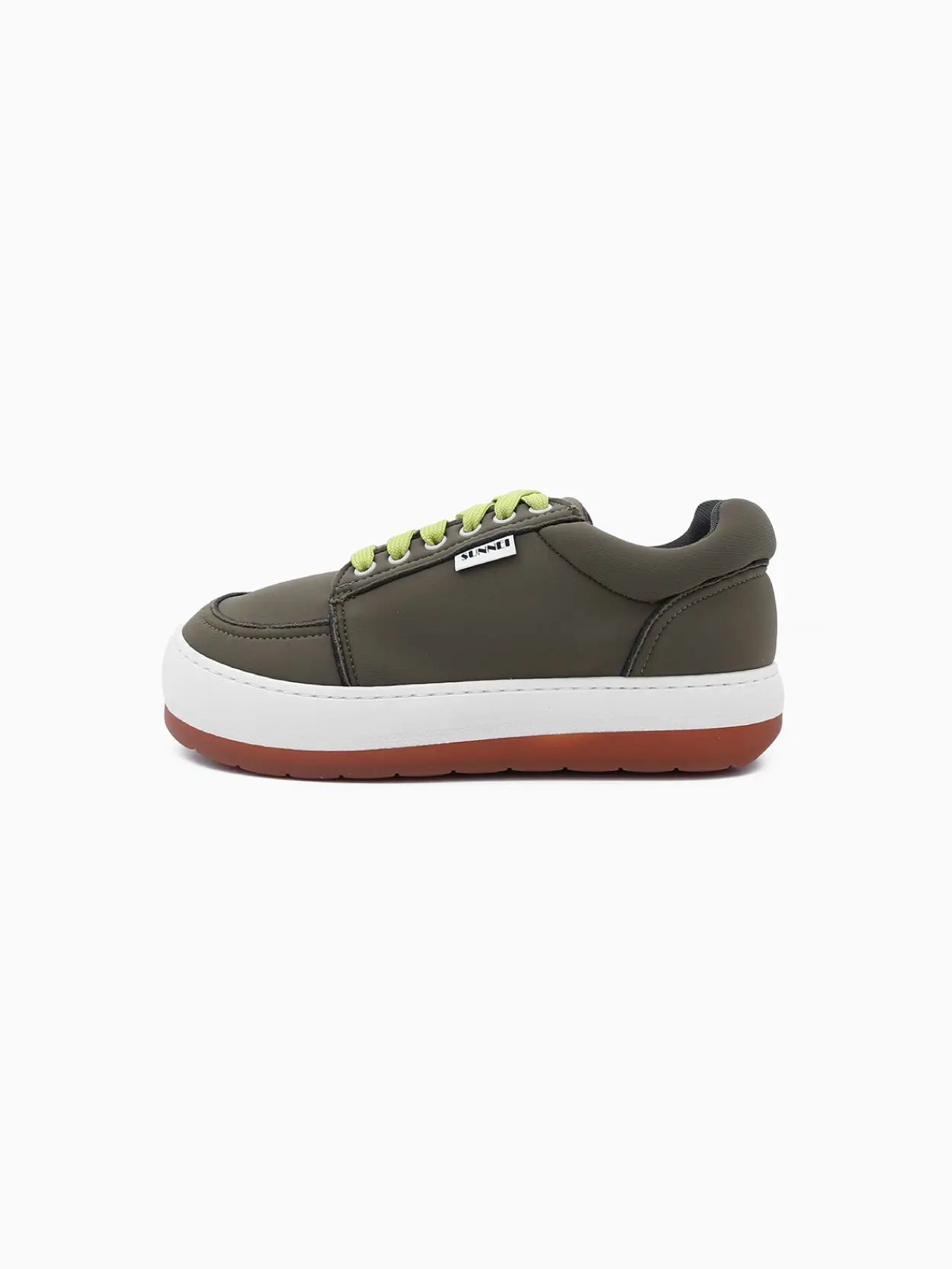 A single olive green sneaker with lime green laces, a thick white midsole, and a brown outsole. The shoe has a small black and white label on the outer side. It is displayed against a plain white background, available exclusively at Bassalstore in Barcelona. This is the Dreamy Shoes Green by Sunnei.