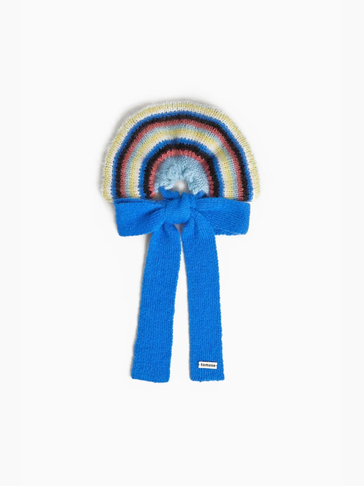 An Elvira Bow Scrunchie by Tomasa resembling a rainbow with pastel colors, transitioning from light to dark hues. It has a light blue center and a bright blue tied end, with a small white label. The background is plain white, perfect for showcasing this charming accessory available at Bassalstore in Barcelona.