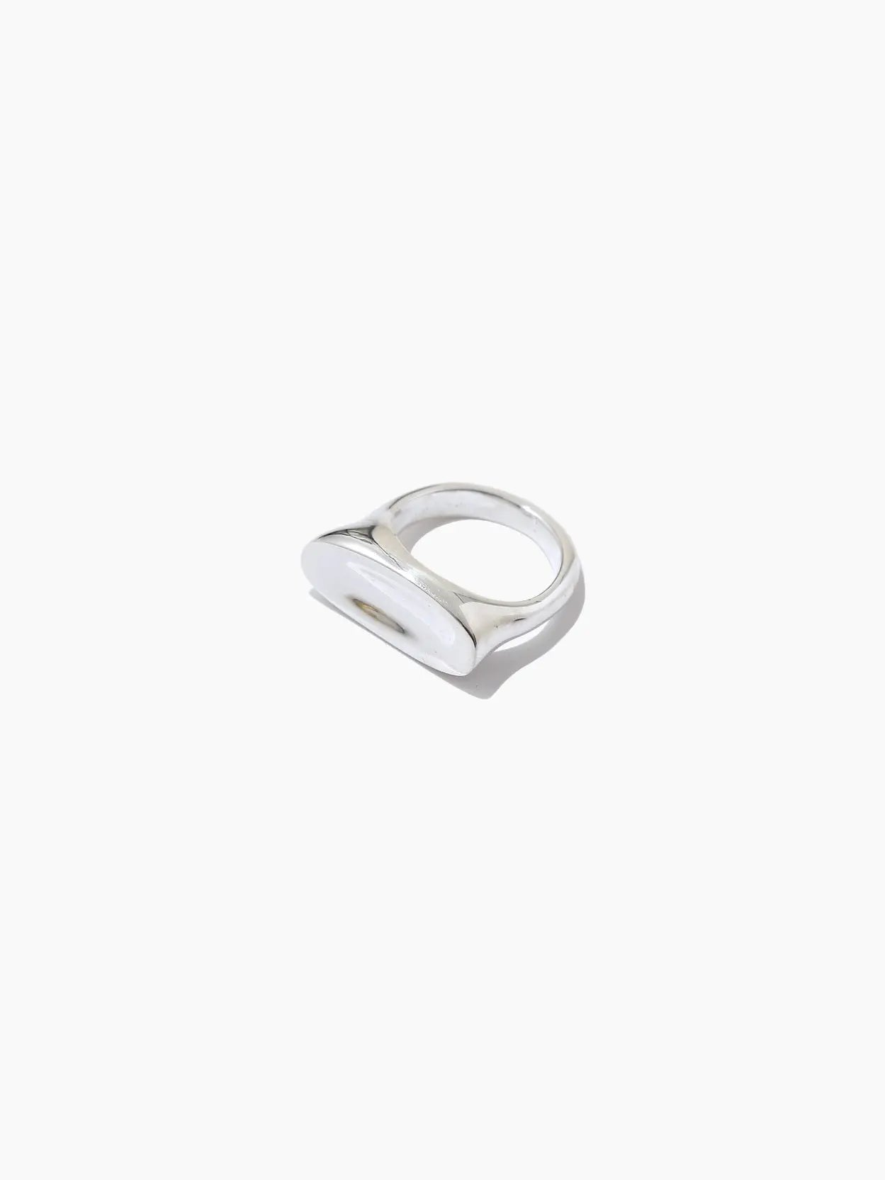 A modern silver ring with a wide, flat top surface displayed against a plain white background, the Fava Ring by Nathalie Schreckenberg is available exclusively at Bassalstore.
