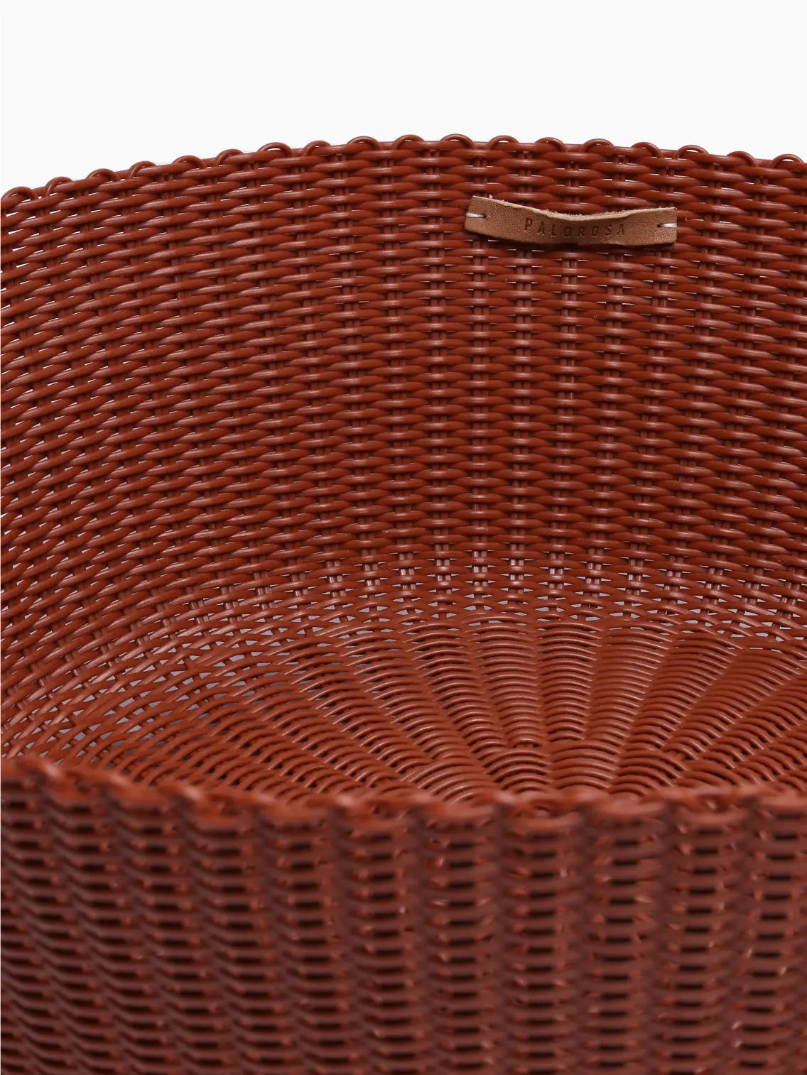 A round, brown wicker basket with a wide opening and textured pattern is displayed on a light, plain background. The Fruit Basket Large Clay by Palorosa, available at Bassalstore Barcelona, appears empty and features an intricate woven design.