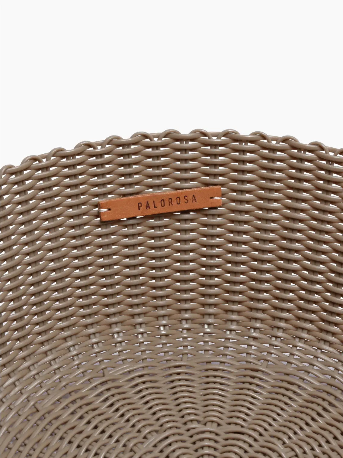 A round, woven basket in a light brown color, available at Bassalstore and placed against a white background. The Palorosa Fruit Basket Sand Small features a classic weave pattern and sturdy edges.