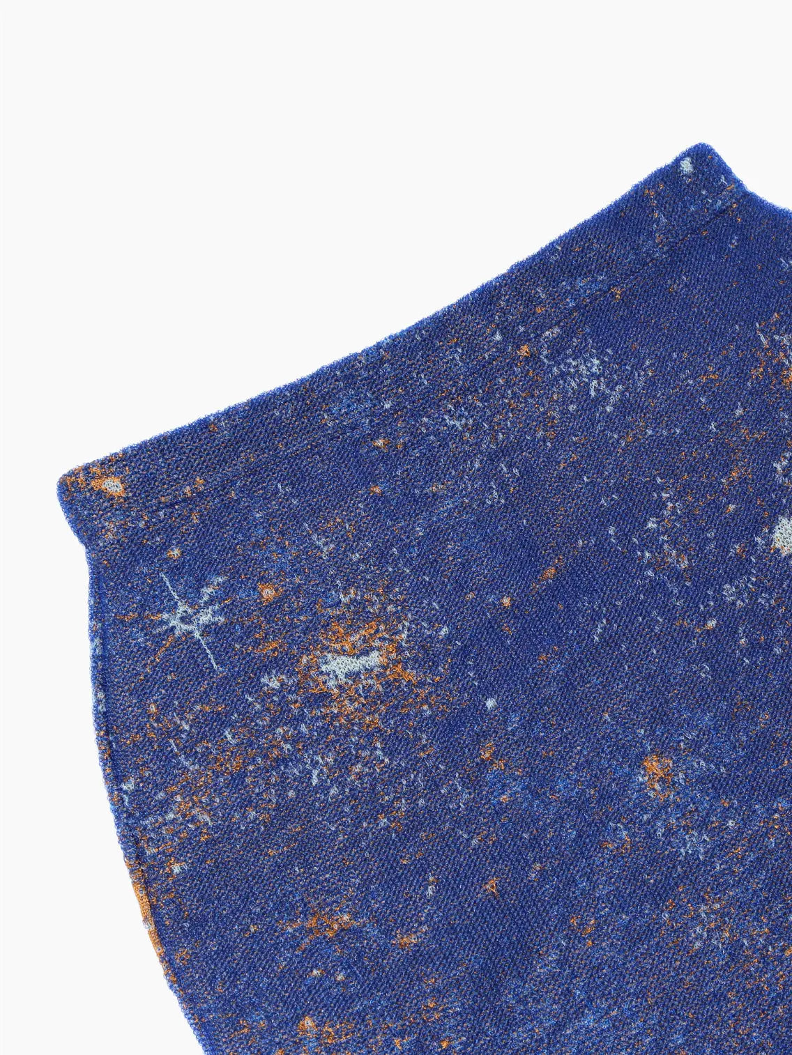 A Bielo Galaxy Skirt Navy, featuring a galaxy-inspired design with blues, oranges, and whites representing stars and cosmic dust on a dark blue background – available exclusively at Bassalstore in Barcelona.