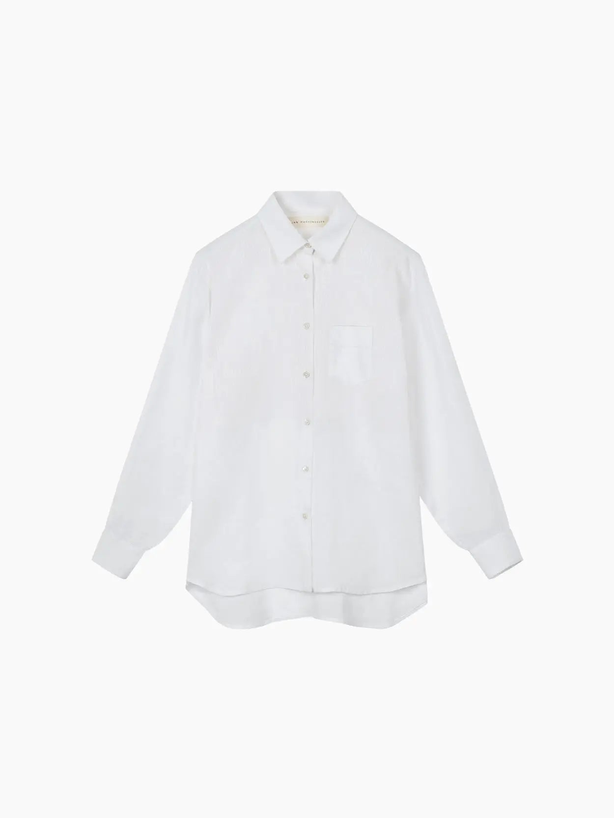 A white long-sleeve button-up shirt with a single chest pocket and a classic collar is neatly displayed against a plain white background. The Galla Linen Shirt Block Print Stripe by Jan Machenhauer, available at Bassalstore in Barcelona, features a relaxed fit with slightly rounded hems.
