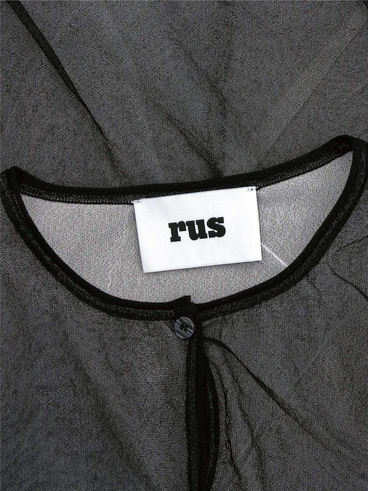 A long-sleeved, sheer black Garasu Cardigan Black with a button-up front and a round neckline by Rus. The fabric appears slightly crinkled. Discover this elegant piece at Bassalstore, your go-to fashion store in Barcelona. The label inside the cardigan reads 'FIL.'.