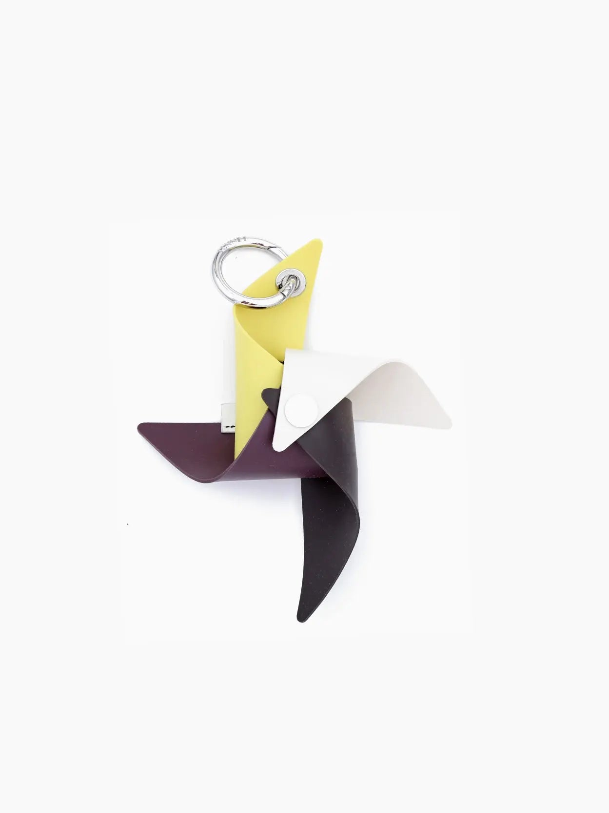 A Gomma Girandola Airpods Holder Multi Off White by Sunnei designed to resemble a pinwheel with four blades, colored yellow, white, dark purple, and dark brown. The metal keyring is attached at the top. This stylish accessory can be found at Bassalstore in Barcelona. The entire design sits against a plain white background.