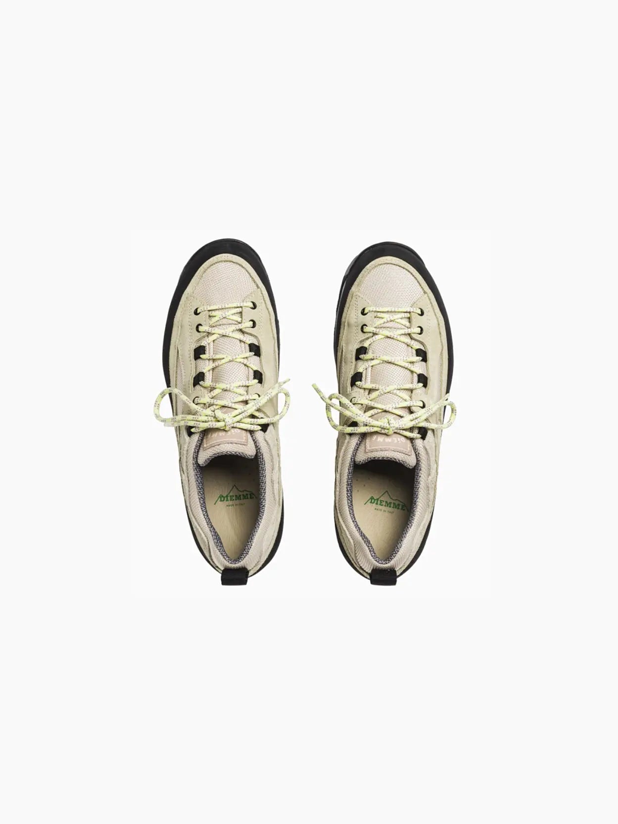 Image of a single Diemme Grappa Hicker Ecru with a beige and black color scheme. The shoe features a low-top design with green laces, a black rubber sole, and a black heel tab for easy wearing. Displayed in side profile on a plain white background, this stylish piece is available at Bassalstore in Barcelona.