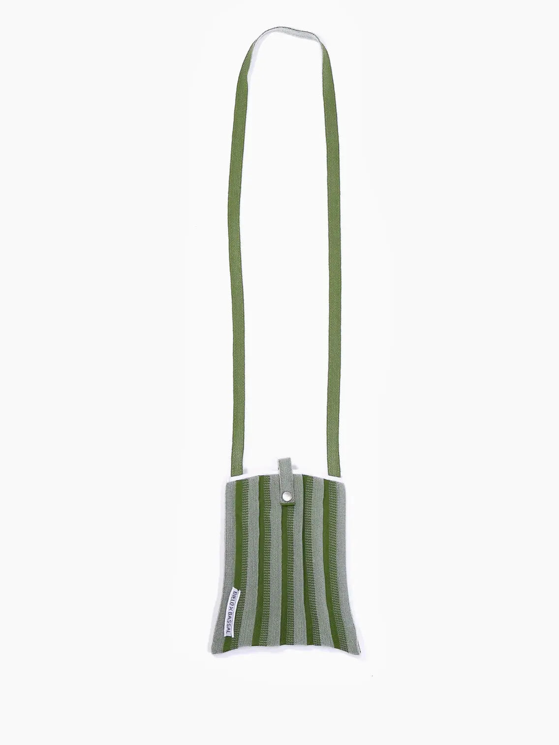 A small green and gray striped fabric bag with a shoulder strap. The Green Shoulder Bag features a snap button closure at the top and a small rectangular label with text on the lower left side. Proudly displayed by Bielo x Bassal Store, this stylish accessory brings a touch of Barcelona charm to your wardrobe against a plain white background.