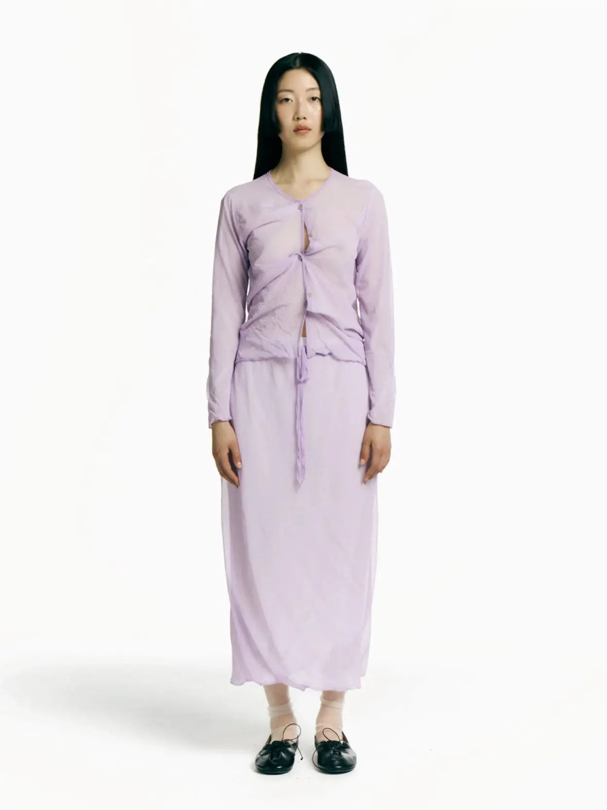 A sheer, light purple skirt with an elastic waistband and adjustable drawstring, perfect for beachwear or layering. The fabric is semi-transparent and lightweight. Displayed flat against a white background, this elegant piece from Rus brings a touch of Barcelona chic to your wardrobe. The Hankachi Skirt Mauve is sure to be a versatile addition to any fashion ensemble.