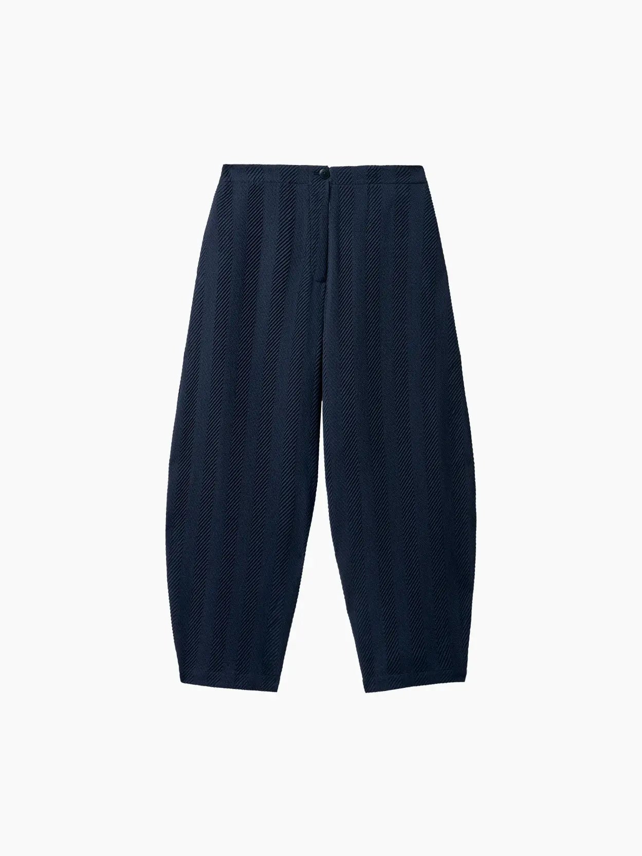 A pair of Herringbone Curved Pants Navy by Cordera displayed against a white background. The pants feature a textured, vertical stripe pattern and are designed with a relaxed fit. Discover this stylish piece at Bassalstore, your go-to store for chic fashion inspired by the vibrant streets of Barcelona.