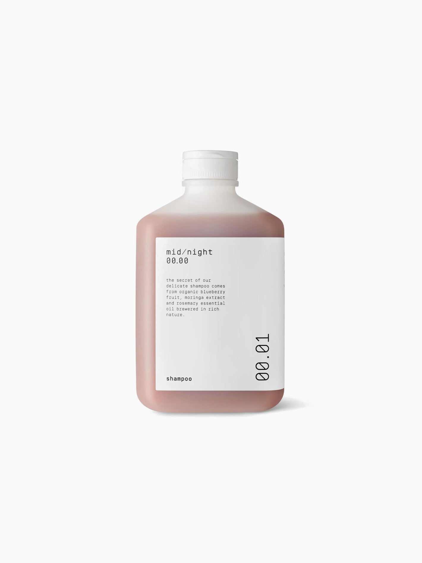 A bottle of shampoo labeled "Shampoo 00.01" from Midnight Cosmetics. The rectangular bottle features a white cap and a minimalist design. The front label highlights the product's sulfate-free formula and scent, promoting hair growth with multivitamin actives. Inside, it contains a light brown liquid.