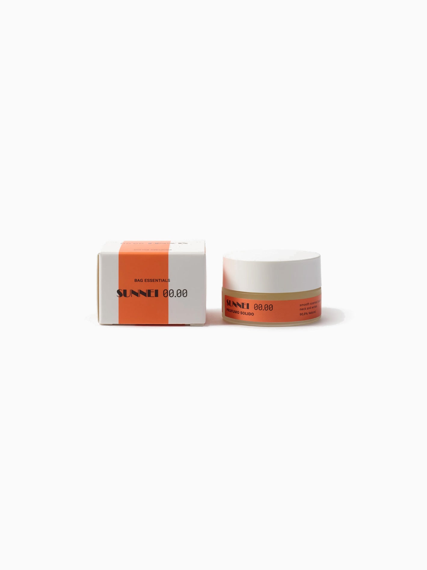 Two small, round cosmetic containers with white lids and orange labels sit side by side on a white background. The left container is a box and the right is a jar, both labeled "Midnight Cosmetics Profumo Solido 00.04," featuring vegan formulations with hints of fig and amber.