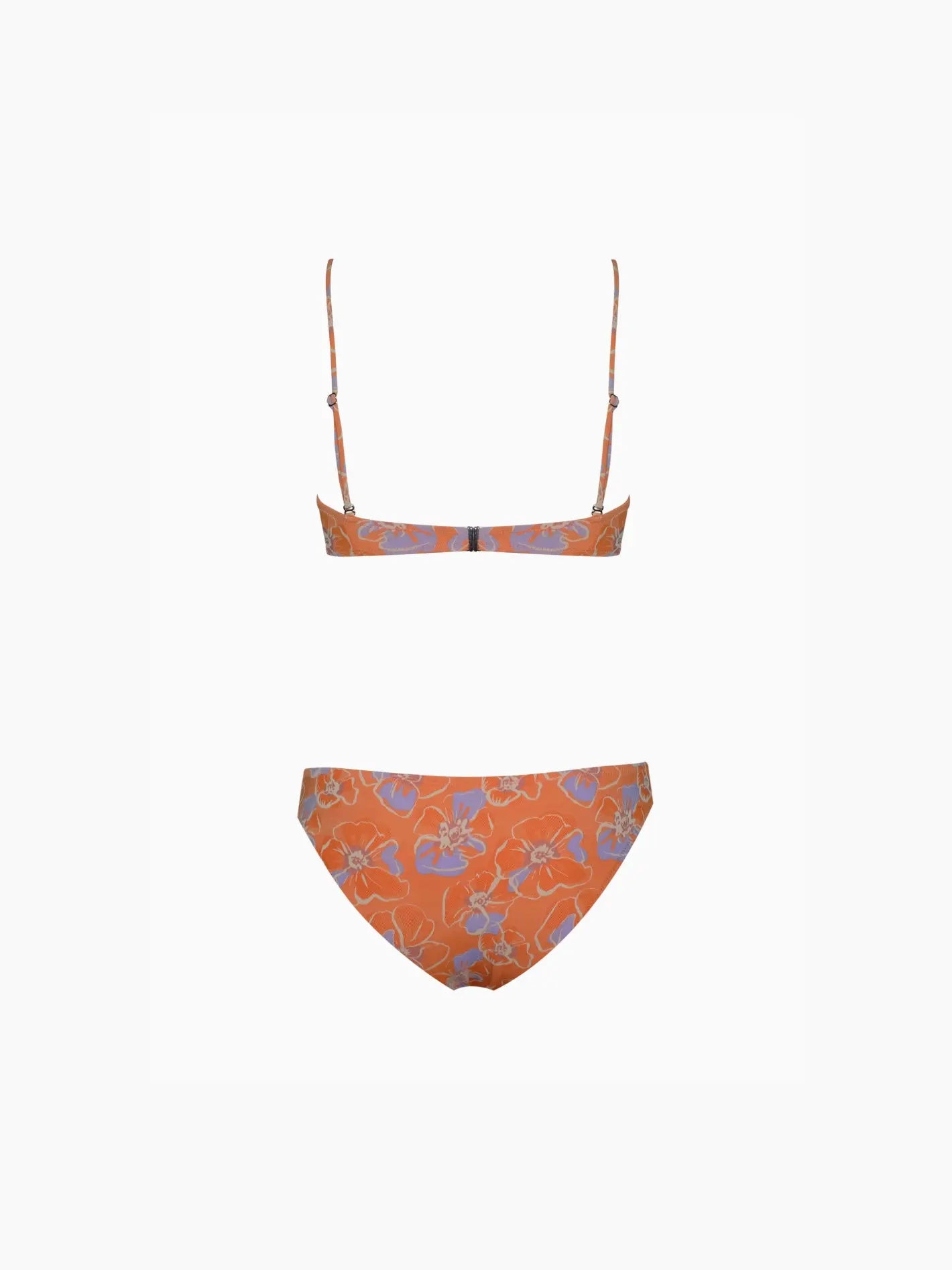 A Marais Bikini Mandarina with thin shoulder straps and a floral pattern. The top is a bandeau style, and the bottoms are classic bikini-cut. The floral design features shades of blue and white. Displayed against a plain white background, this stunning piece from Pale is available at Bassalstore in Barcelona.