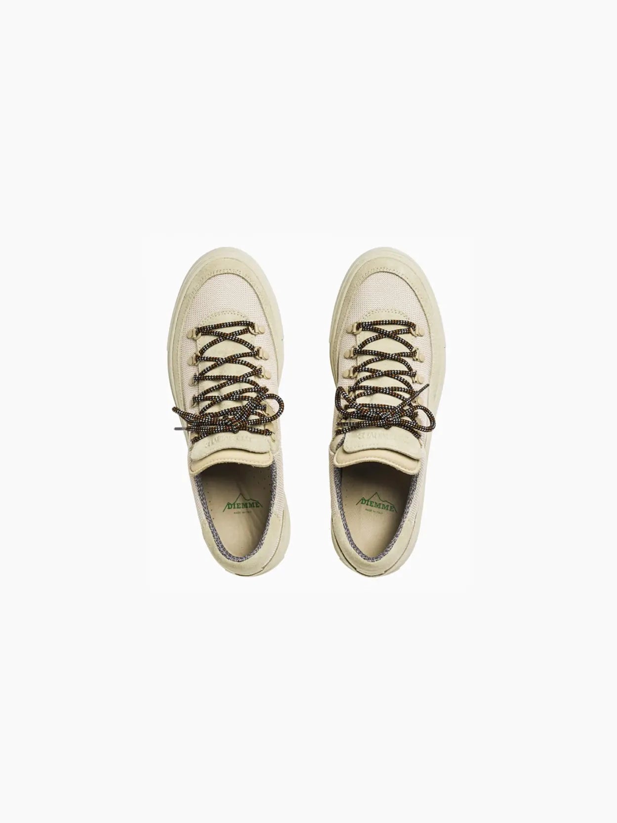Displayed at Bassalstore in Barcelona, the Diemme Marostica Low Ecru boasts a low-top design. The shoe features round, brown and beige laces threaded through metal eyelets. The sole and toe cap are matching beige, and the sneaker has a minimalist style with subtle stitching details.