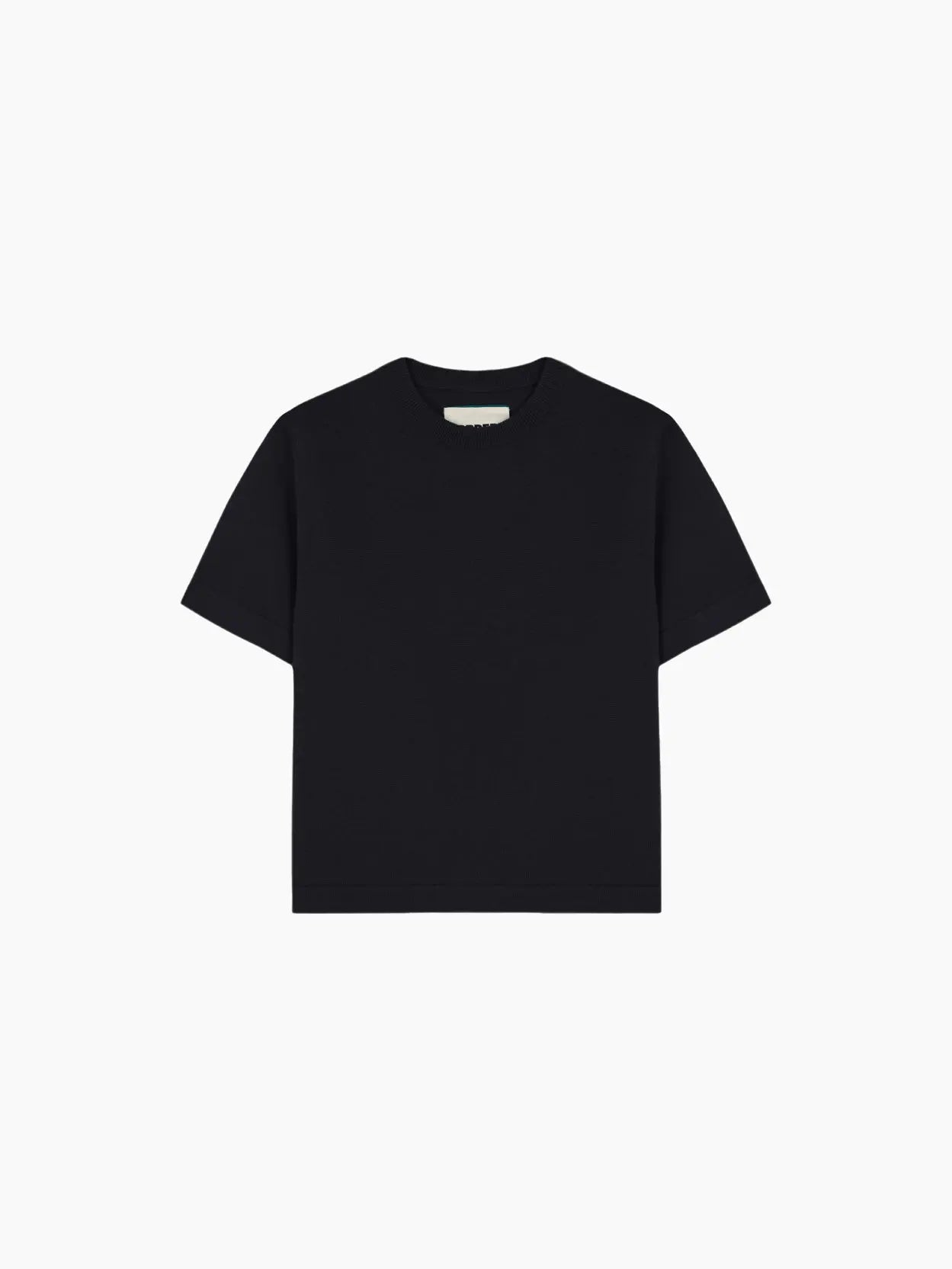 A plain, short-sleeved, black Merino Wool T-Shirt is displayed against a white background. The T-shirt features a simple crew neck design and is free of any logos, patterns, or graphics. This minimalist staple by Cordera can be found at BassalStore in Barcelona.