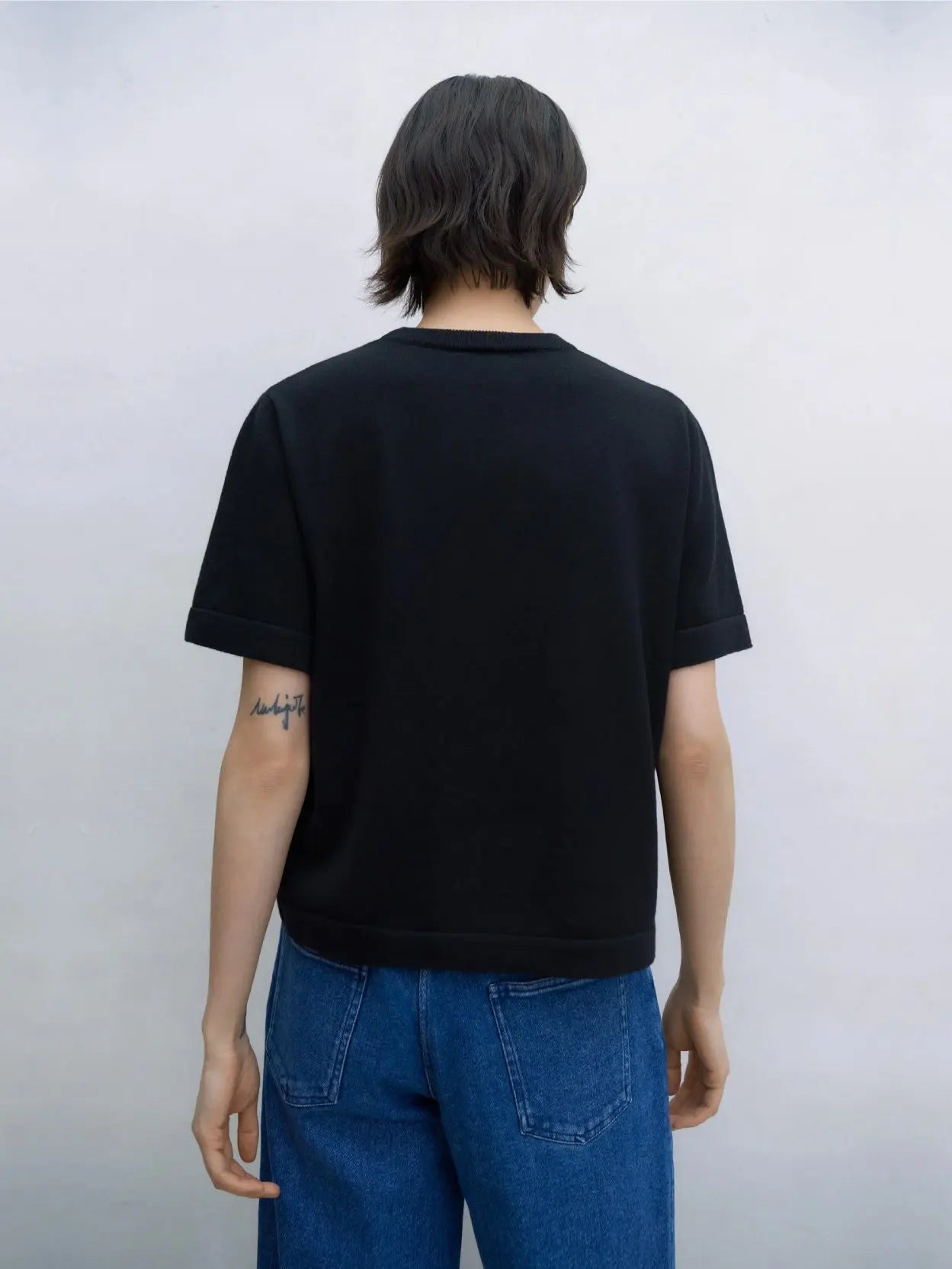 A plain, short-sleeved, black Merino Wool T-Shirt is displayed against a white background. The T-shirt features a simple crew neck design and is free of any logos, patterns, or graphics. This minimalist staple by Cordera can be found at BassalStore in Barcelona.