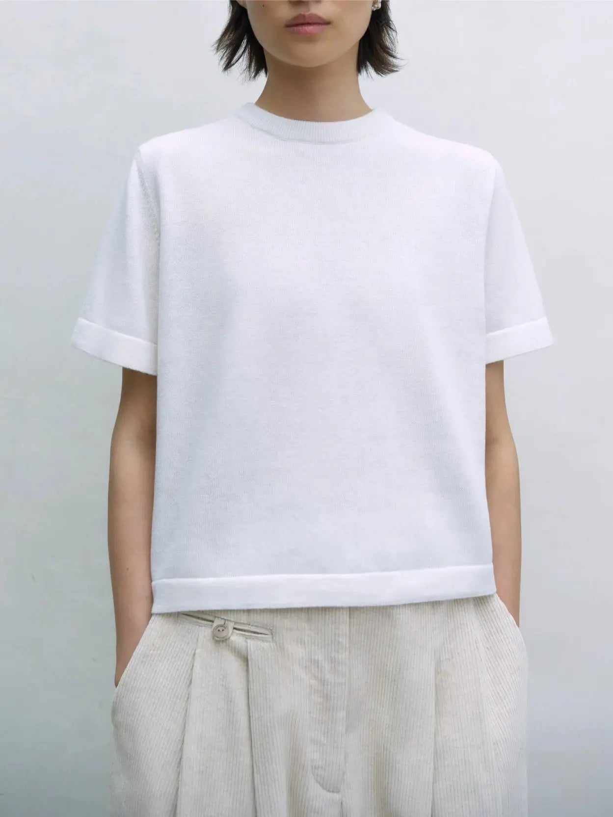 A plain white short-sleeve Merino Wool T-Shirt from Cordera is displayed against a white background. The T-shirt, available at this trendy Barcelona store, features a round neckline and a simple, clean design with no visible logos or patterns.