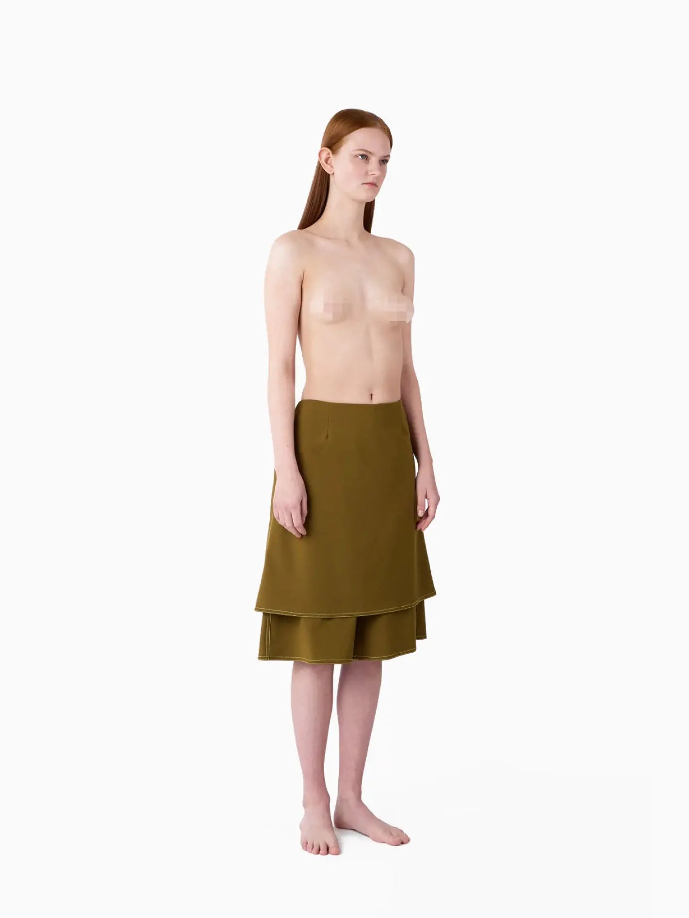 A Panta Skirt Olive Green by Sunnei is centered against a plain white background. The skirt, available at Bassalstore in Barcelona, has a straight cut, with the top layer ending above the second layer, creating a tiered look.